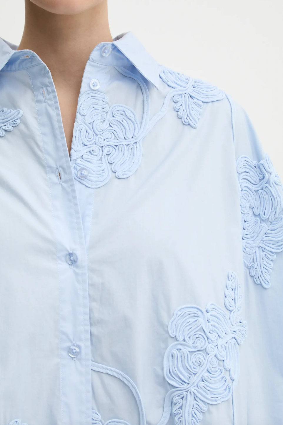 Elevate your style with this high-waisted maxi skirt crafted from sustainable organic cotton. Its flowing, flared design moves gracefully, enhanced by delicate tonal floral embroidery that adds elegant texture. With carefully tailored gathering at the waistband and a hidden side zipper, it offers a flattering fit and lasting comfort. Ideal for sophisticated events, this skirt combines refined elegance with eco-conscious craftsmanship to enhance your wardrobe effortlessly.