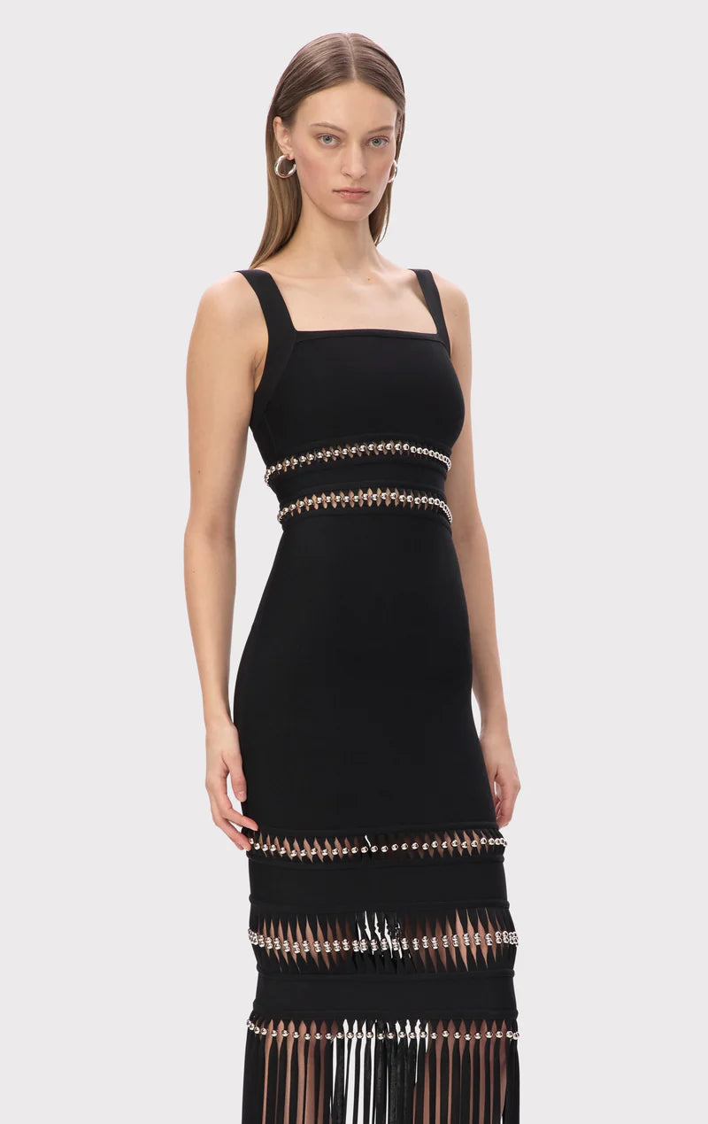 The Ines Gown by Hervé Léger epitomizes modern elegance with its expertly engineered body-contouring midi silhouette designed to enhance your natural curves. The bold square neckline makes an unforgettable statement, while meticulously hand-placed silver beads create a mesmerizing shimmer that captures light with every movement. Strategically positioned cutouts reveal just enough skin to add sophisticated allure, proving that true luxury lies in the perfect balance between coverage and confidence. 