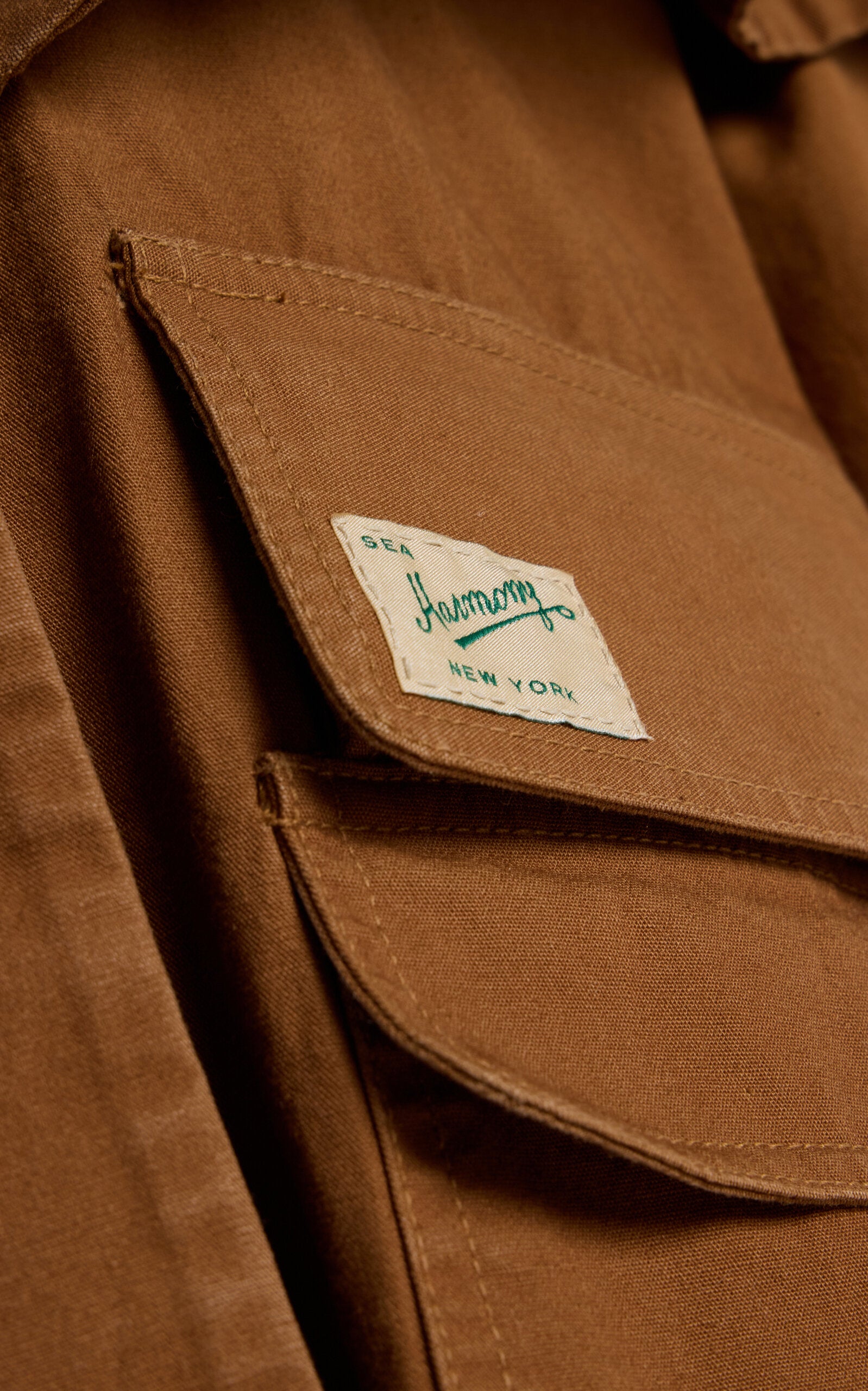 Embrace effortless sophistication with the Carolyn Cape-Detailed Cotton Workwear Jacket by SEA NY. This statement piece combines utilitarian charm with unexpected elegance, featuring a structured oversized silhouette crafted from crisp cotton canvas. The signature flouncy capelet adds a playful twist to classic workwear styling, making it perfect for elevating everyday looks or creating bold, fashion-forward outfits. 