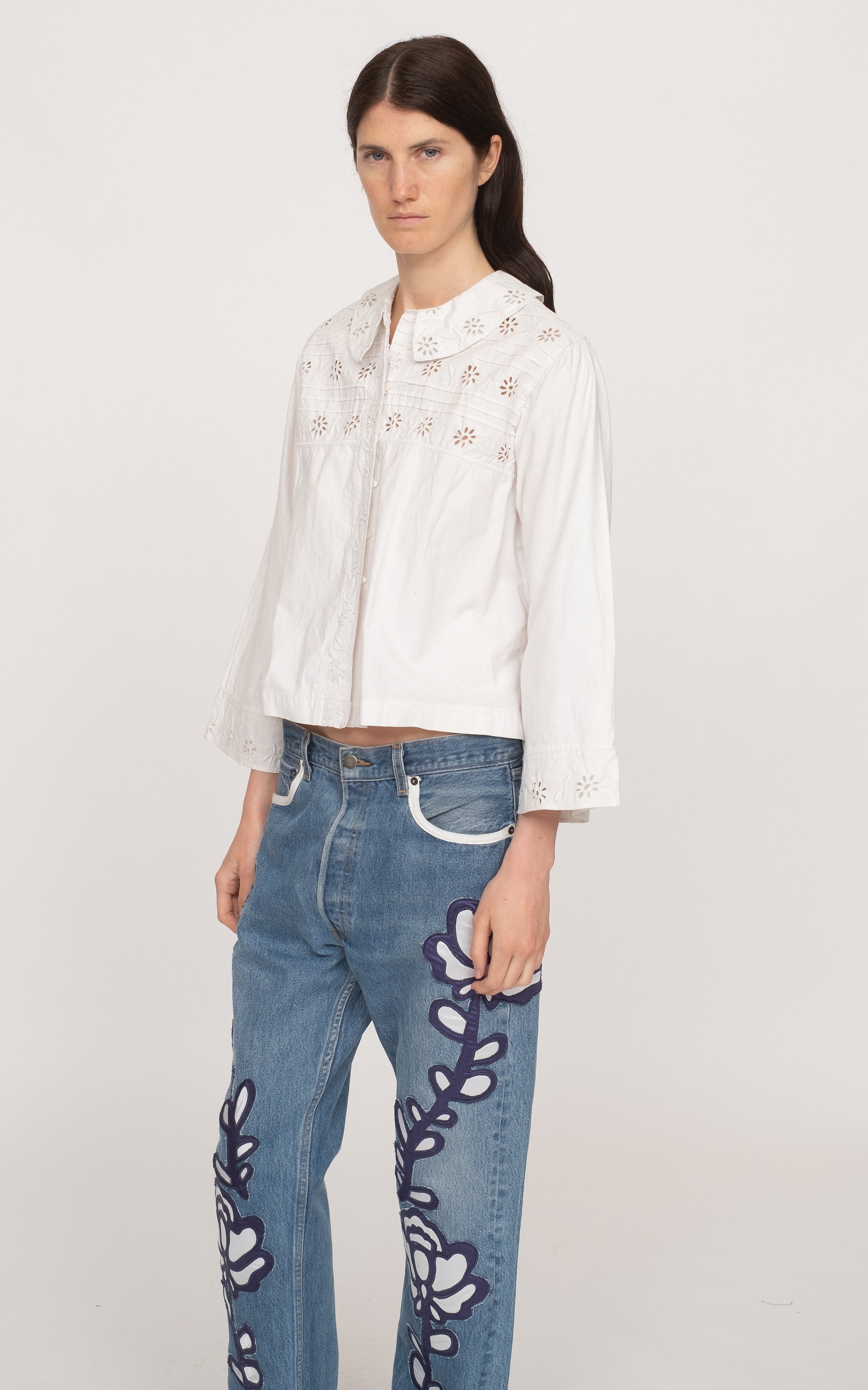 Get ready to rock the fashion world with the Paloma Eyelet Top! This collared top features a relaxed fit and is made with 100% cotton for ultimate comfort. Unlined for a breezy feel, it comes in a classic white color and has a button and zip fastening. Perfect for a casual yet chic look!