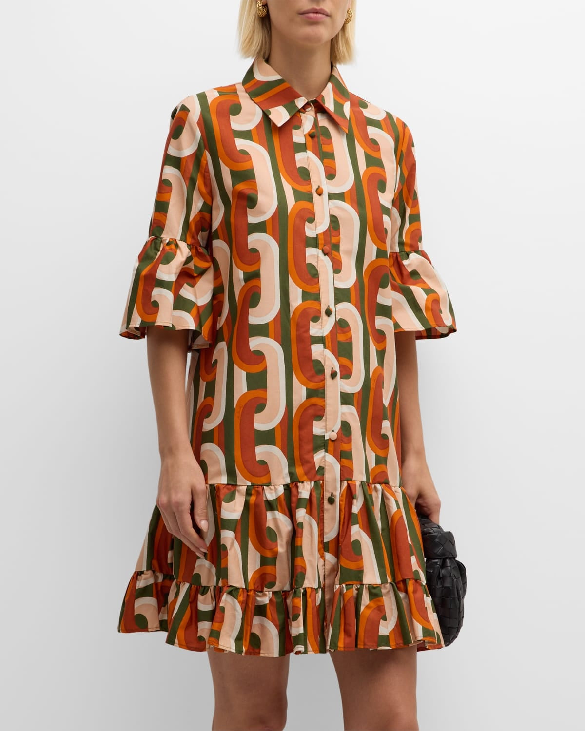 Elevate your everyday wardrobe with the DoubleJ Choux shirtdress, a sophisticated Italian-crafted piece that effortlessly transitions from day to night. This cotton mini dress features an eye-catching chain-link print and charming tiered ruffle hem that adds movement and dimension. The classic point collar and button-front design offer timeless appeal, while practical side split pockets keep essentials within reach. 