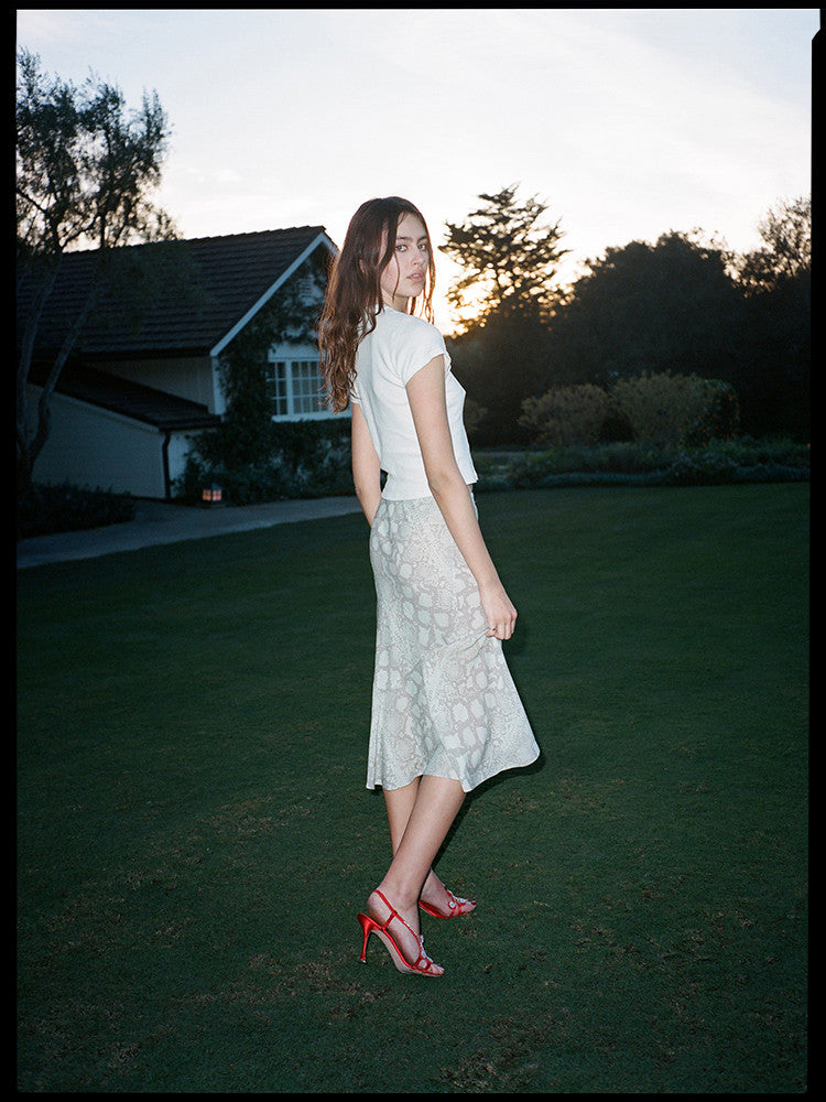 Experience the flirty and feminine charm of The Carmen in Absinthe by Realisation Par. This modern skirt features a flattering silhouette and fluted hemline that adds movement to every step. Perfect for any occasion, pair it with a fitted knit or crisp white tee for a versatile and effortless look. Indulge in classic charm with a touch of modern sophistication.