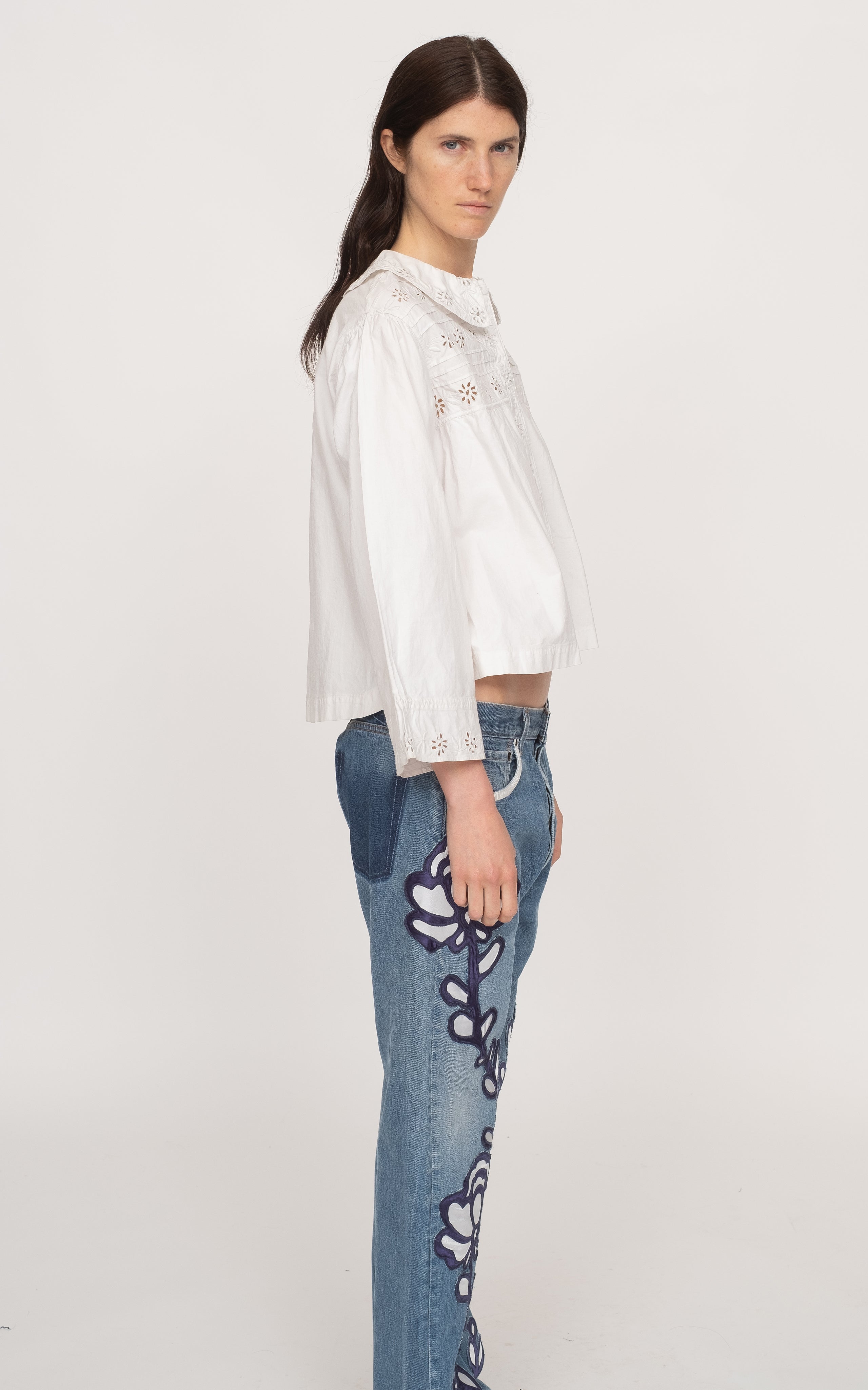 Get ready to rock the fashion world with the Paloma Eyelet Top! This collared top features a relaxed fit and is made with 100% cotton for ultimate comfort. Unlined for a breezy feel, it comes in a classic white color and has a button and zip fastening. Perfect for a casual yet chic look!