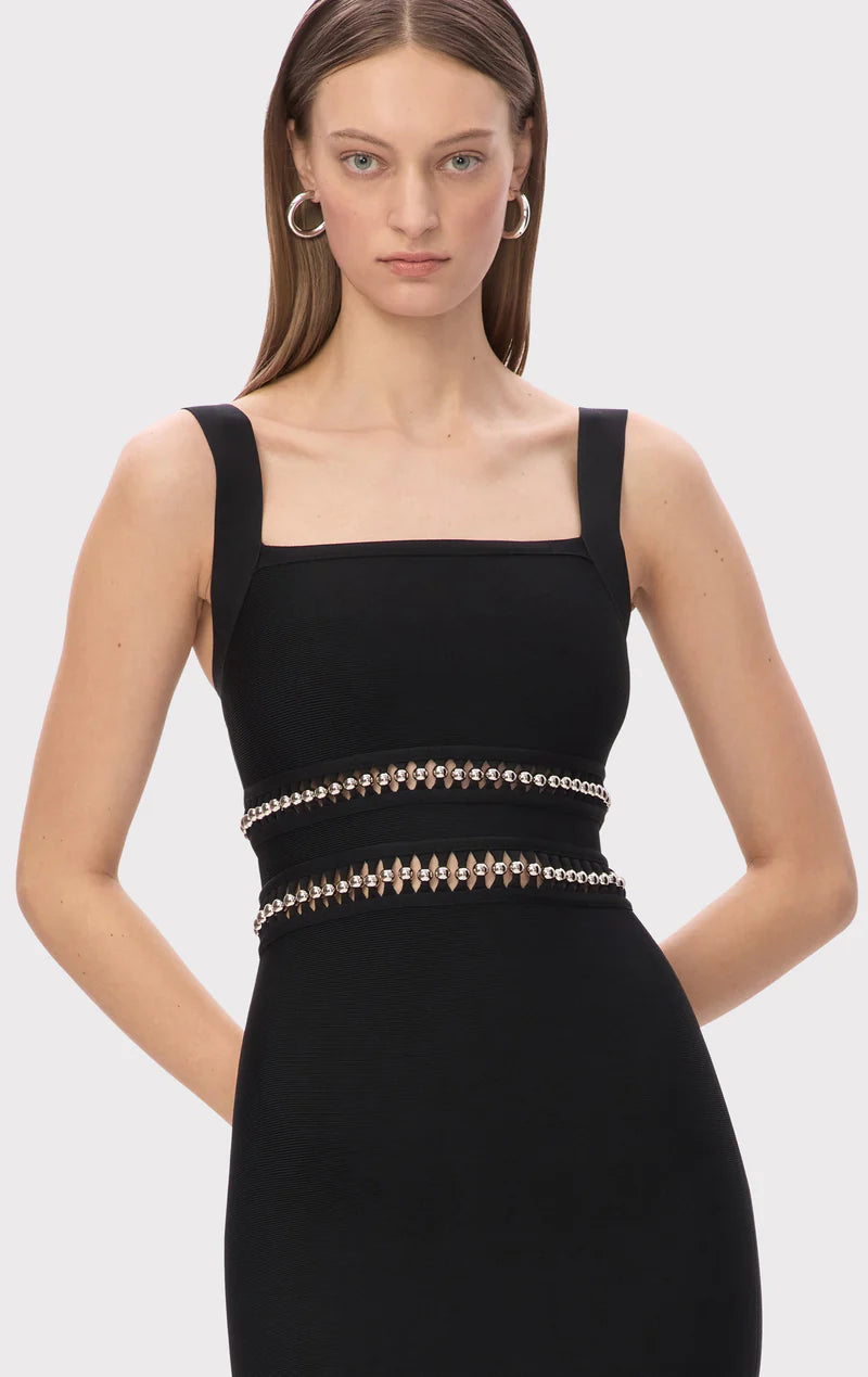 The Ines Gown by Hervé Léger epitomizes modern elegance with its expertly engineered body-contouring midi silhouette designed to enhance your natural curves. The bold square neckline makes an unforgettable statement, while meticulously hand-placed silver beads create a mesmerizing shimmer that captures light with every movement. Strategically positioned cutouts reveal just enough skin to add sophisticated allure, proving that true luxury lies in the perfect balance between coverage and confidence. 