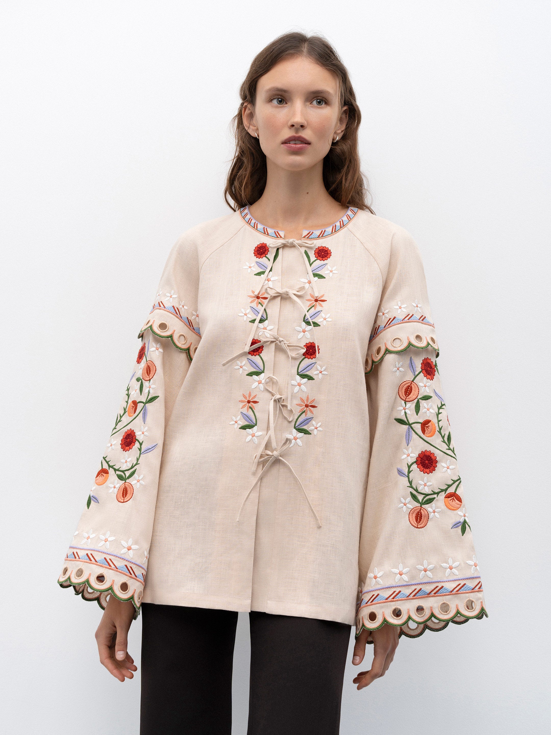 Get ready to turn heads with the Leena Embroidered Blouse! This stylish blouse features a beautiful 3D flower embroidery, flared sleeves, and a chic lace-up neckline. Embrace your unique fashion sense with this vintage-inspired piece.