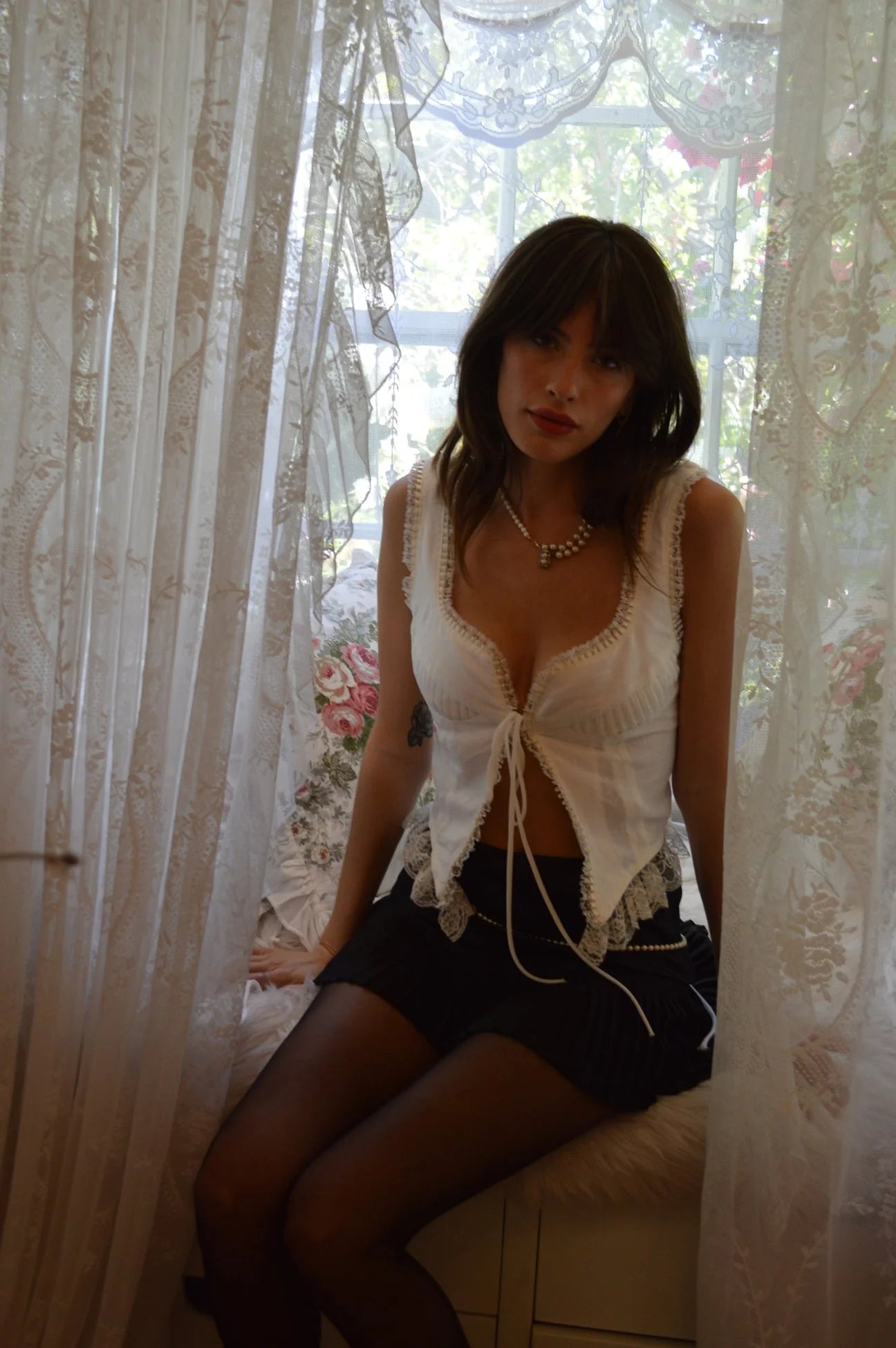 Indulge in the sophistication of the Top Renee. Crafted with 100% linen, its tie front and adjustable back ties provide the perfect fit. The delicate lace and pintuck detailing add a touch of elegance to this timeless piece. Elevate your wardrobe with this luxurious top.