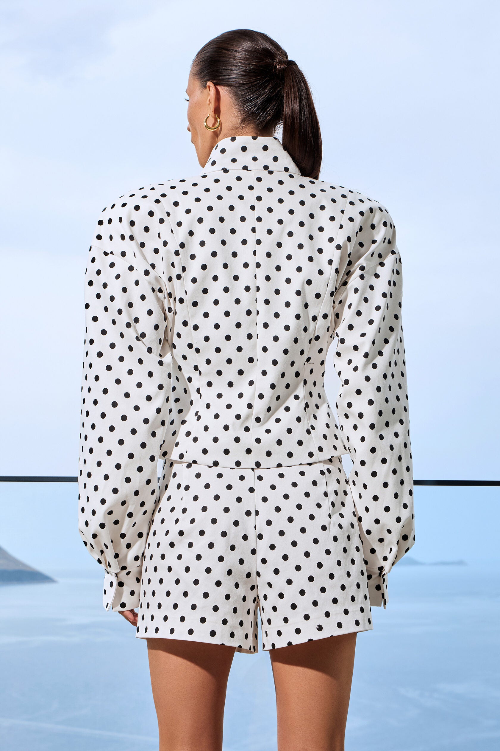 Elevate your casual wardrobe with this two-piece polka dot set featuring a standout stand collar jacket and coordinating shorts. The relaxed silhouette and long sleeves deliver effortless sophistication, while the playful dot pattern adds contemporary flair. Perfect for creating that coveted casual-chic aesthetic, this versatile ensemble transitions seamlessly from weekend errands to night-out moments. Embrace edgy streetwear style without compromising comfort.