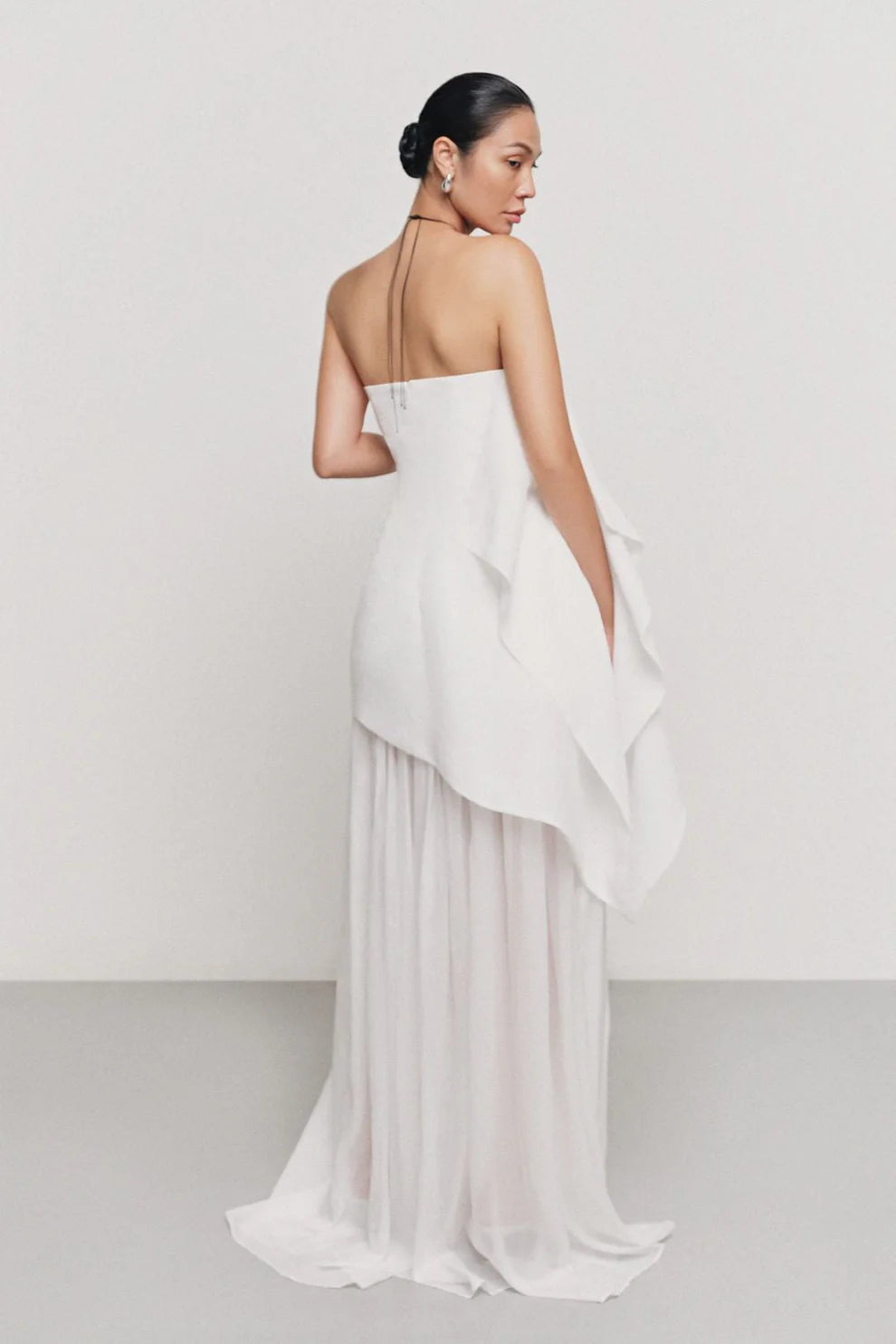 Indulge in luxury with our Gina Silk Maxi Dress. Made from premium silk chiffon, this strapless dress features elegant gatherings for a flattering and sophisticated fit. Perfect for special occasions, elevate your style with this stunning and exclusive piece.