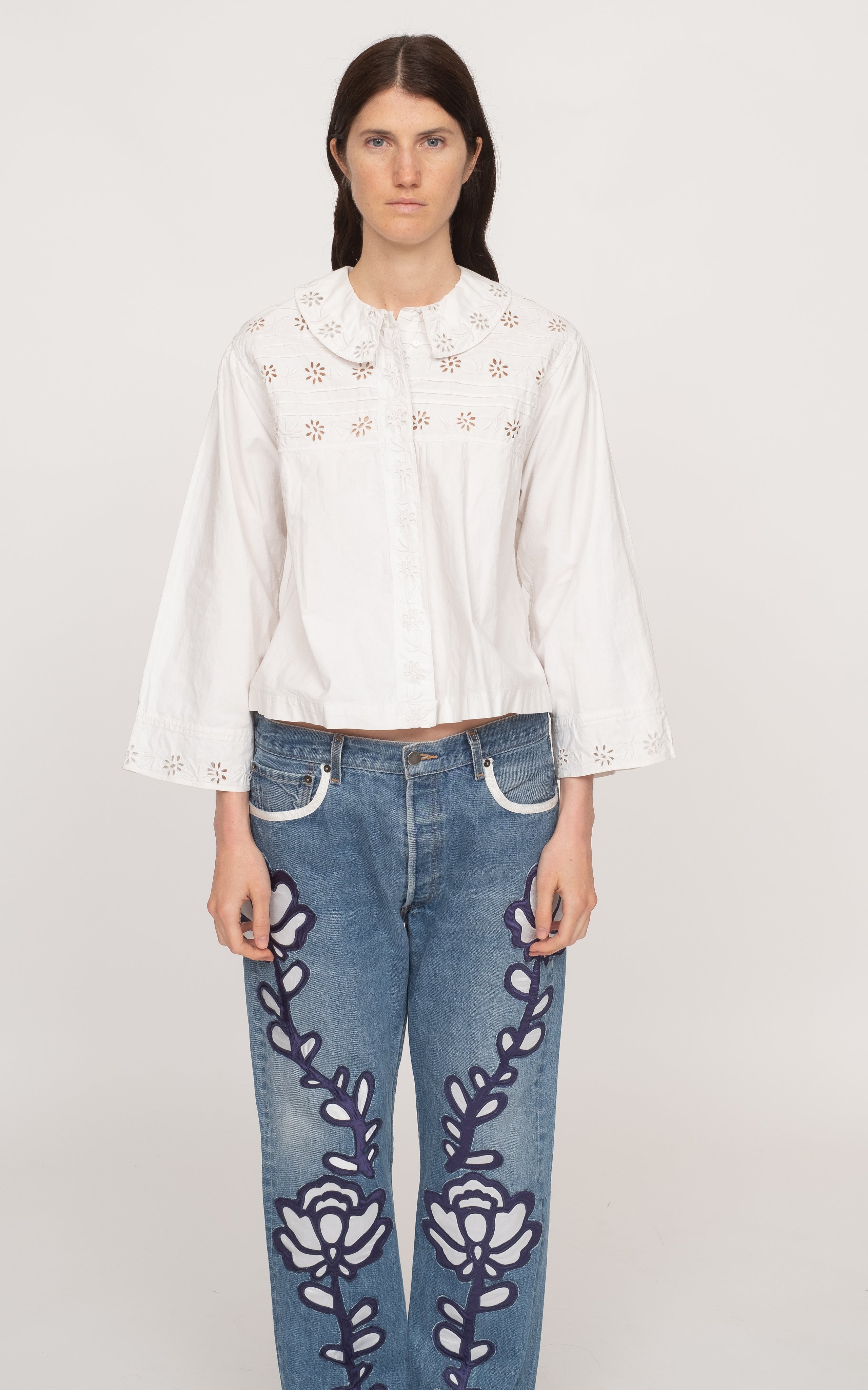 Get ready to rock the fashion world with the Paloma Eyelet Top! This collared top features a relaxed fit and is made with 100% cotton for ultimate comfort. Unlined for a breezy feel, it comes in a classic white color and has a button and zip fastening. Perfect for a casual yet chic look!