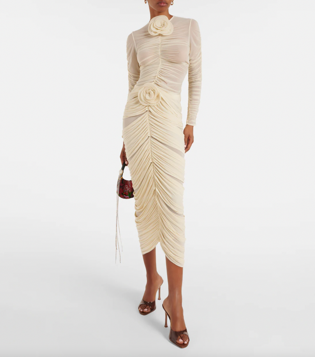 Elevate your style with the exquisite Magda Butrym Floral-appliqué ruched top. Made from a luxurious blend, this designer beige top features delicate floral appliqués and a flattering ruched design. Finished with a hook-fastening back closure, it's the perfect choice for a fashion-forward wardrobe. Made in Poland.