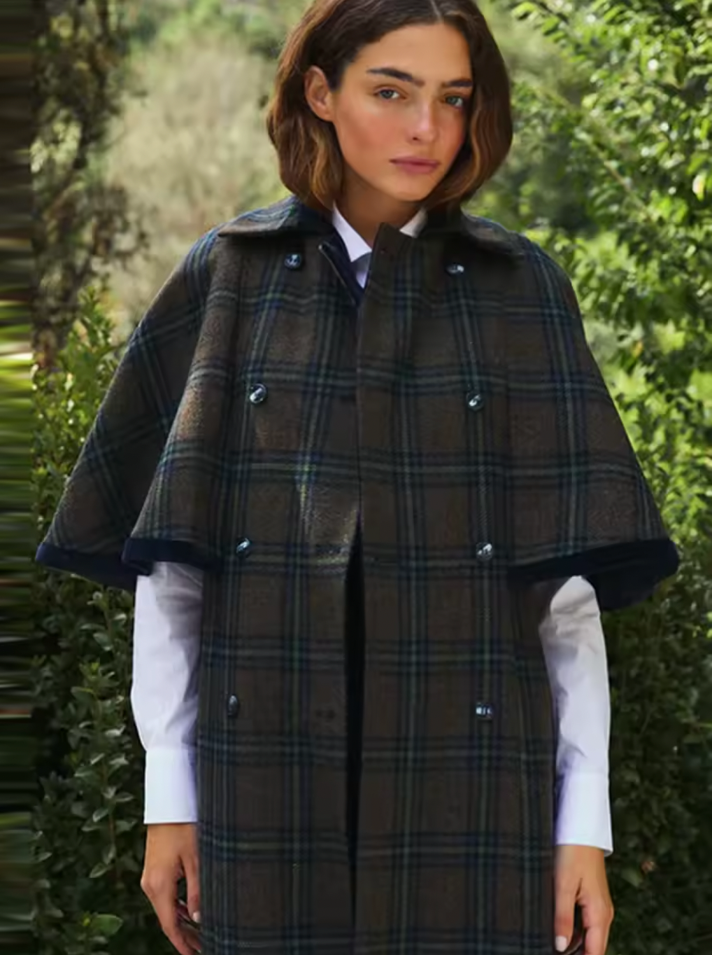 Experience timeless elegance with the Brynne Coat, crafted from a cozy wool blend for warmth and durability. Its maxi trench style features a stylish cape overlay, creating a relaxed fit that layers effortlessly over your favorite outfits. Designed to keep you comfortable on crisp autumn days, this coat blends vintage charm with contemporary flair, making it an indispensable piece for elevating your wardrobe with sophistication and comfort.