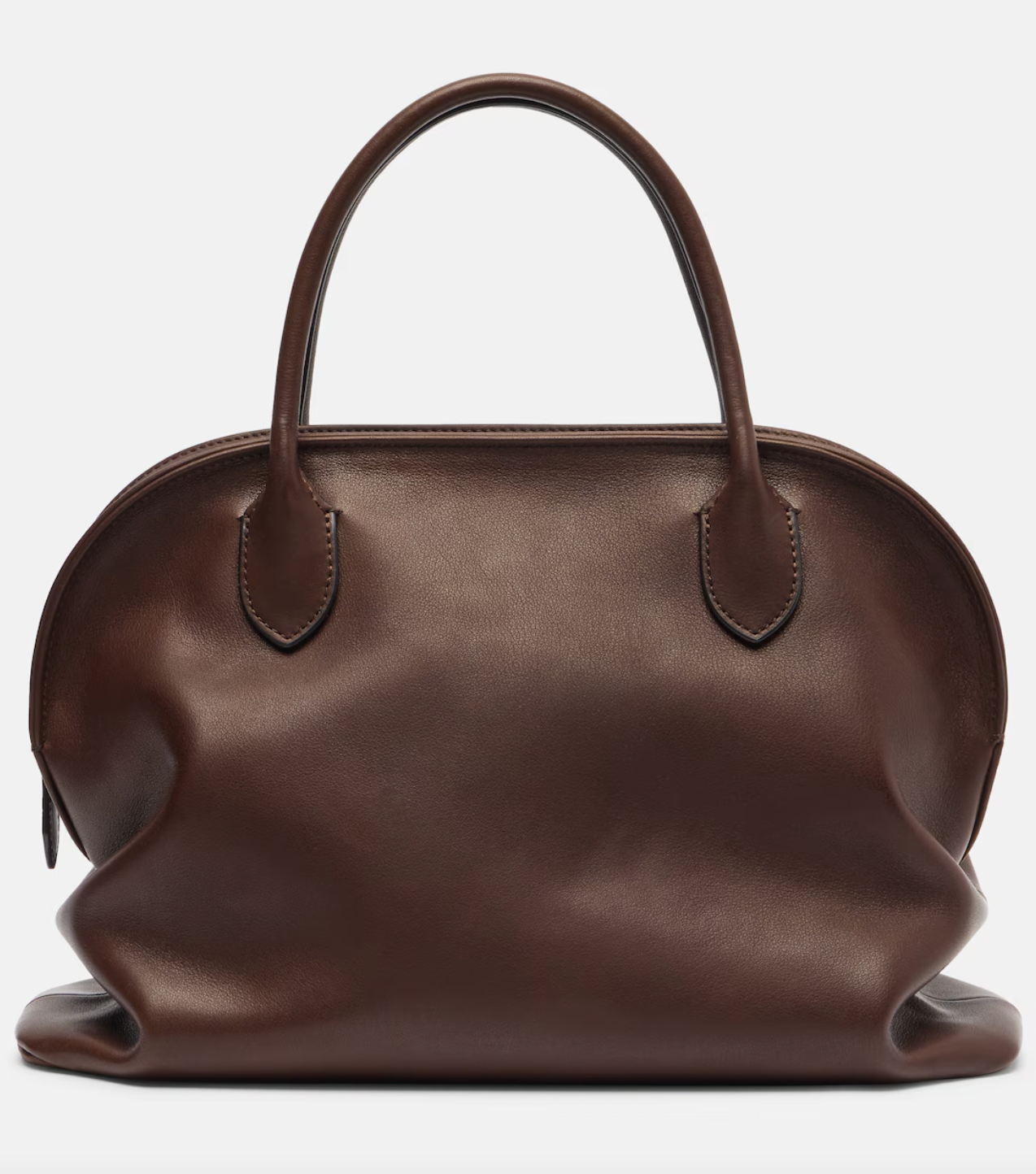 The Agnes tote by The Row combines understated luxury with everyday practicality. Crafted from polished saddle leather, this sophisticated bag features a softly slouched silhouette that moves with you, paired with sturdy tubular handles for effortless carrying. The secure zipper closure keeps your essentials protected while maintaining the bag's refined aesthetic. Perfect for those who appreciate timeless design and quality craftsmanship, the Agnes transitions seamlessly from work to weekend.