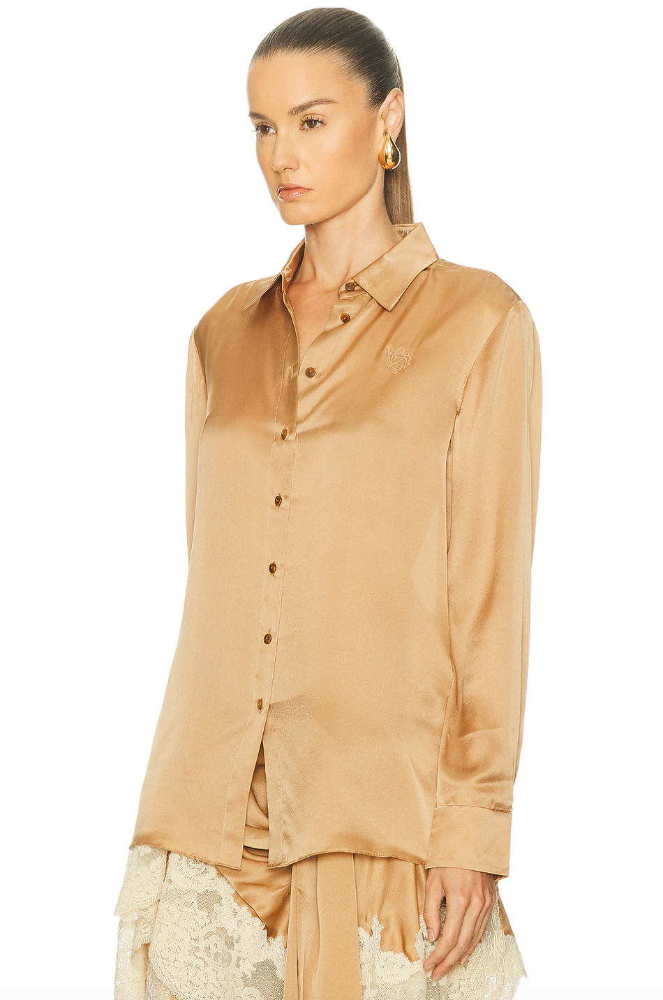 The Hypnotic Satin Shirt by Zimmermann blends effortless elegance with subtle details. Its lightweight satin fabric offers a smooth, breathable feel, perfect for all-day comfort. Featuring a front button closure and button cuffs, this shirt delivers a refined fit. The delicate embroidered logo on the front adds a touch of sophistication, making it an ideal choice for both casual and polished looks. Elevate your wardrobe with this versatile, stylish piece.