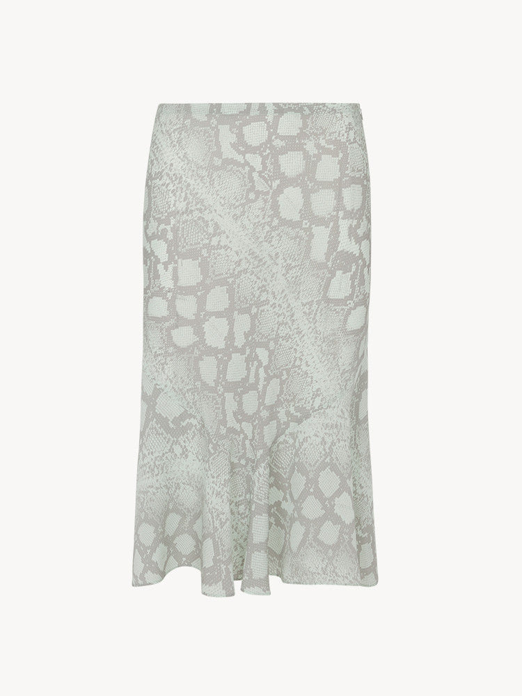 Experience the flirty and feminine charm of The Carmen in Absinthe by Realisation Par. This modern skirt features a flattering silhouette and fluted hemline that adds movement to every step. Perfect for any occasion, pair it with a fitted knit or crisp white tee for a versatile and effortless look. Indulge in classic charm with a touch of modern sophistication.