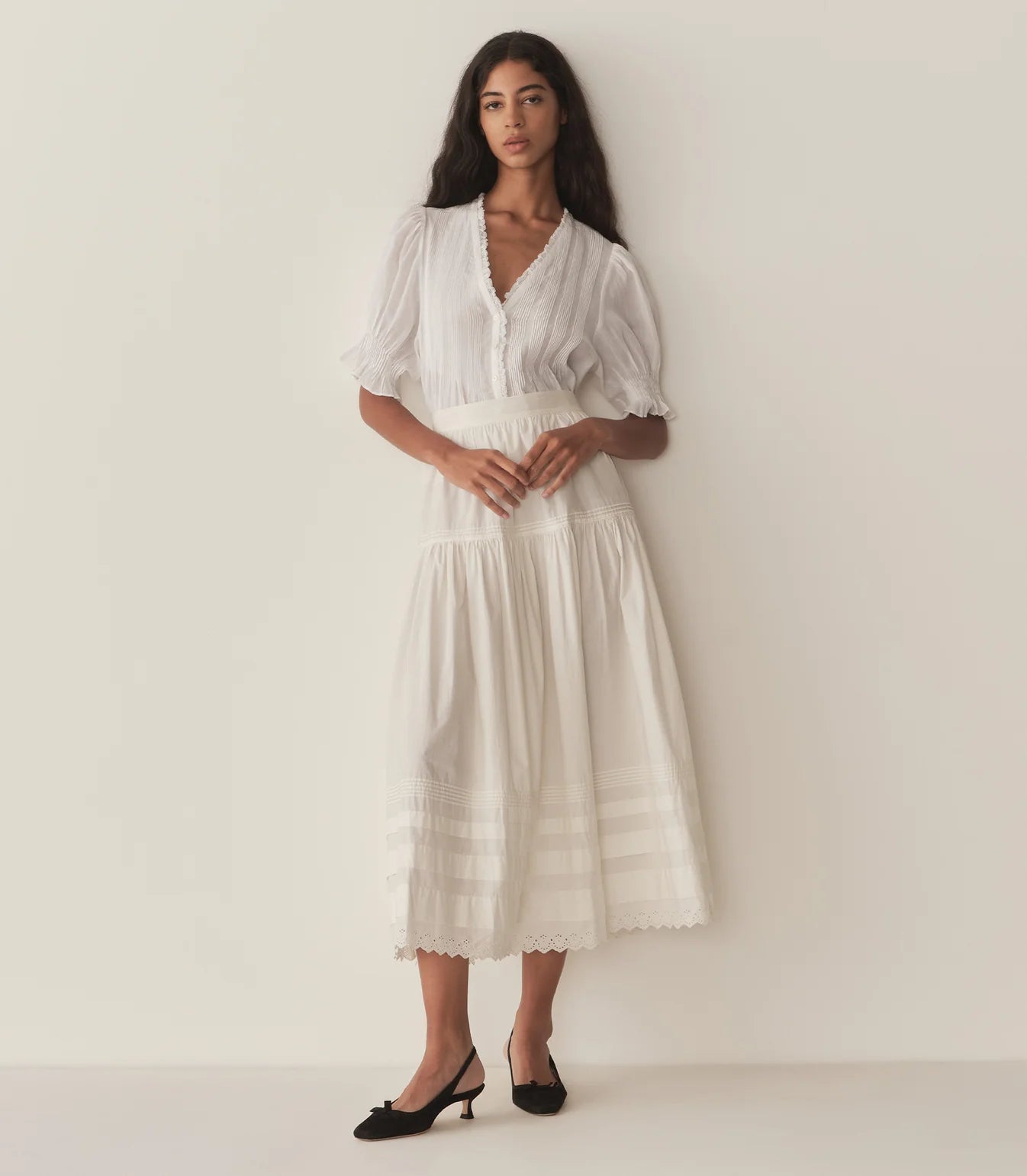 Experience timeless elegance with the Karlie Top, crafted from lightweight ramie for a delicate, airy feel. Its plunging V-neckline framed by soft ruffles and intricate pintuck detailing adds a touch of vintage charm. The starburst button line down the front enhances its refined look, while short puffed sleeves bring a playful silhouette. Perfect for wearing loose or tucked into high-waisted jeans, this versatile top effortlessly elevates any outfit with a graceful Edwardian-inspired style.