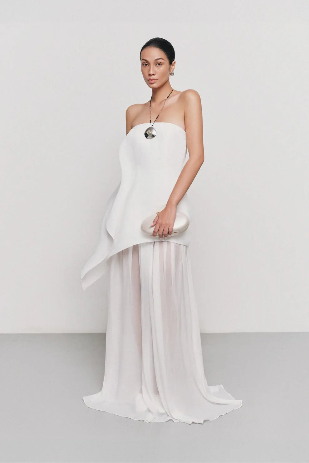Indulge in luxury with our Gina Silk Maxi Dress. Made from premium silk chiffon, this strapless dress features elegant gatherings for a flattering and sophisticated fit. Perfect for special occasions, elevate your style with this stunning and exclusive piece.