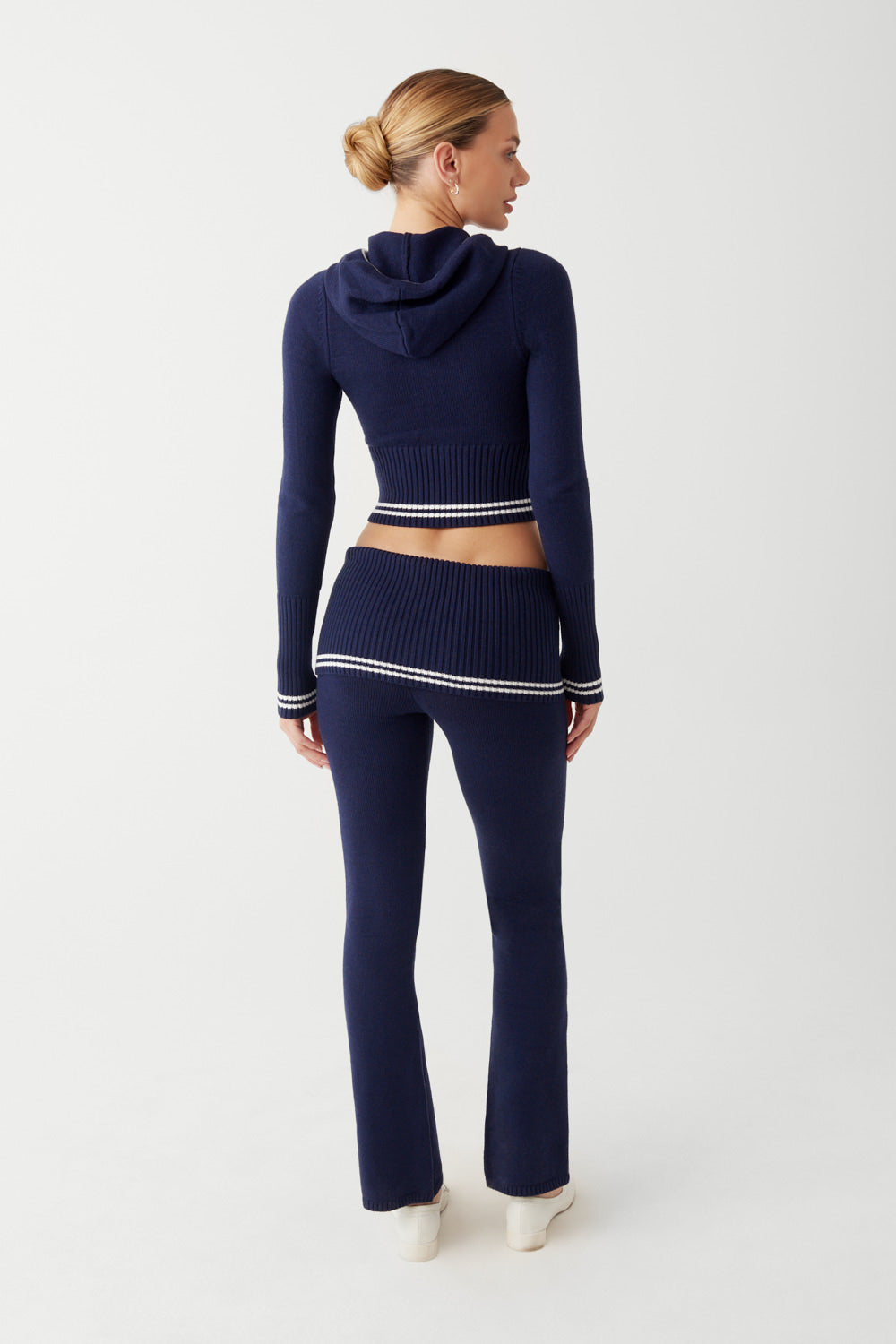 Elevate your loungewear with the Aimee Cloud Knit Zip Up Hoodie by Frankies Bikinis. Made with ultra-soft knit fabric, ribbed cuffs and waist, and a zip-up front, the Aimee hoodie combines comfort and style effortlessly. Pair it with the matching Fleur pant for the ultimate cozy and chic outfit.