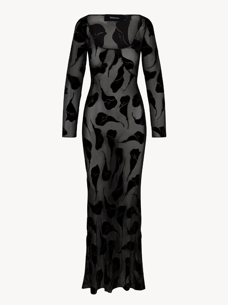 The Inka Dress in Falling Lily Devore combines elegance and subtle allure with its long, semi-sheer design that offers just the right amount of coverage. Featuring a deep neckline and a bias-cut skirt, it captures the ethereal grace of Kate Bush and the bohemian spirit of Joni Mitchell. Ideal for cooler summer nights, this dress pairs beautifully with sky-high heels to create a look of effortless, sexy femininity.