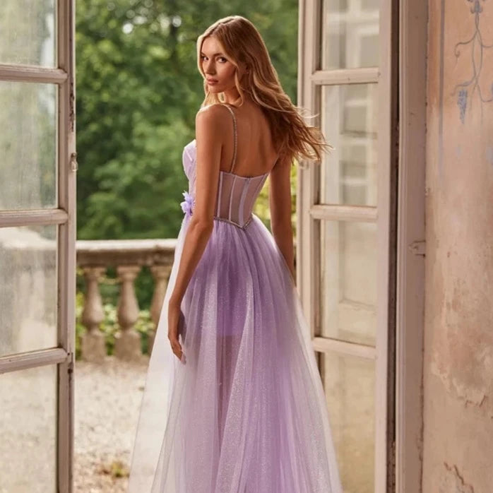 Indulge in a Floral Fantasy with our stunning Jeaninne Robe. The glamorous sequin tulle evening gown features a sexy high-split design for a stunning silhouette. Show off your feminine side with the illusion prom dress, perfect for any formal occasion. You'll be the talk of the night.