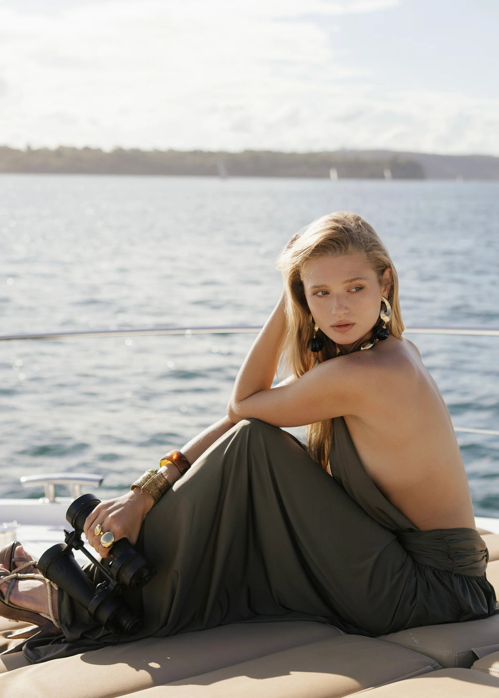 Introducing Santina by Arcina Ori—where sophistication meets movement. This khaki halter dress captivates with its fluid draping and sensual design details, including a ruched centre back and strategically placed gathers that flatter your silhouette. The low-set waistband and floor-length hem create an elongated, graceful line, while the open back design adds an element of allure perfect for making an entrance. 