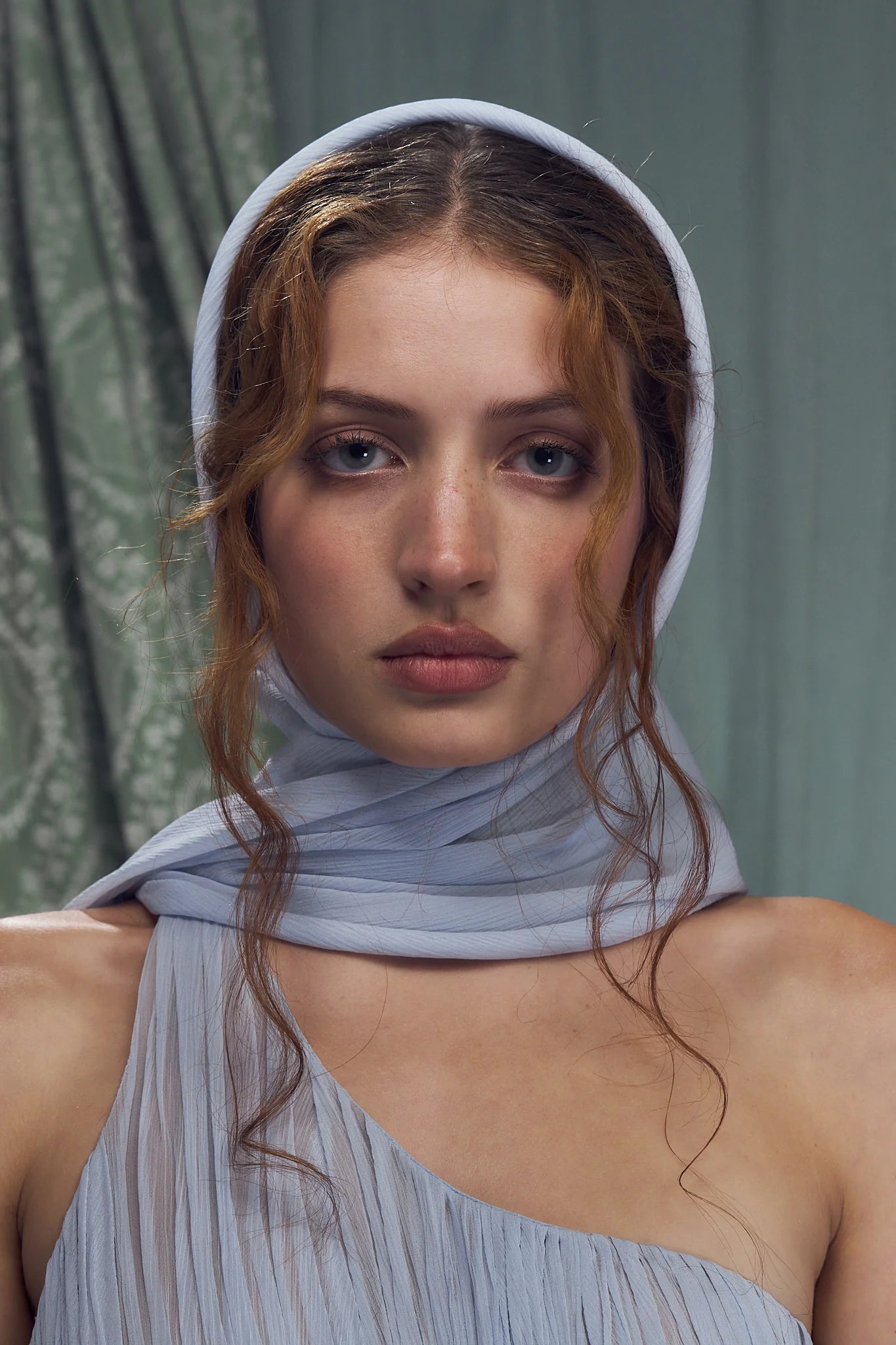 Embrace elegance with the Hellenistic Gown in Ciel, designed to captivate with a one-shoulder silhouette crafted from delicate crinkle chiffon. Its underwire cups and power mesh lining provide comfortable support and a flawless fit, while the attached scarf adds a touch of grace. The high slit offers sophisticated allure, and the invisible zipper with hook and eye closure ensures a seamless look. Perfect for making a memorable entrance, this gown combines style and confidence effortlessly.