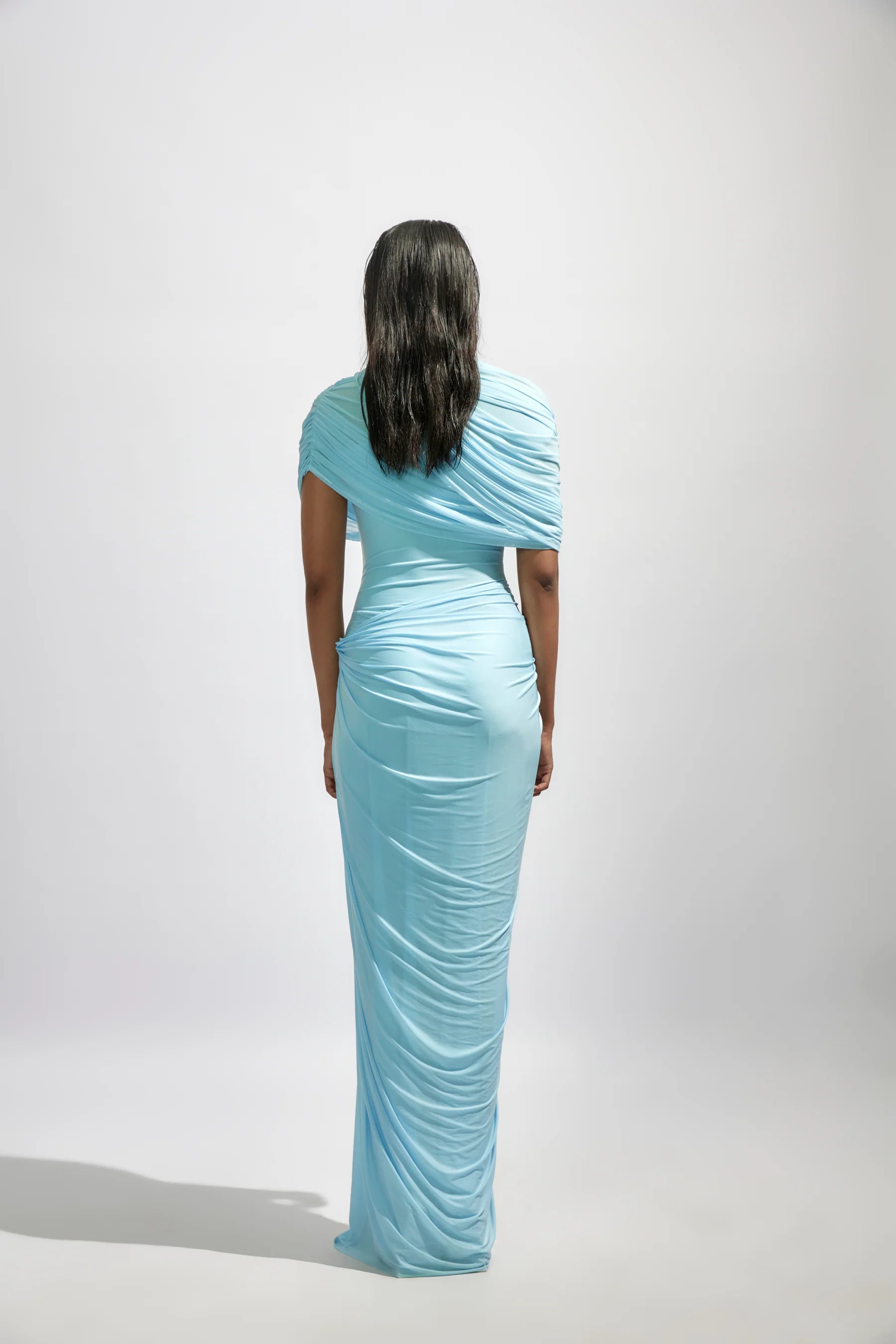 The Jasmine Dress features a fully draped design enhanced by delicate pleated details, adding texture and graceful movement. Its elegant silhouette and refined pleats bring timeless sophistication, making it an ideal choice for special occasions where you want to stand out with confidence and style.