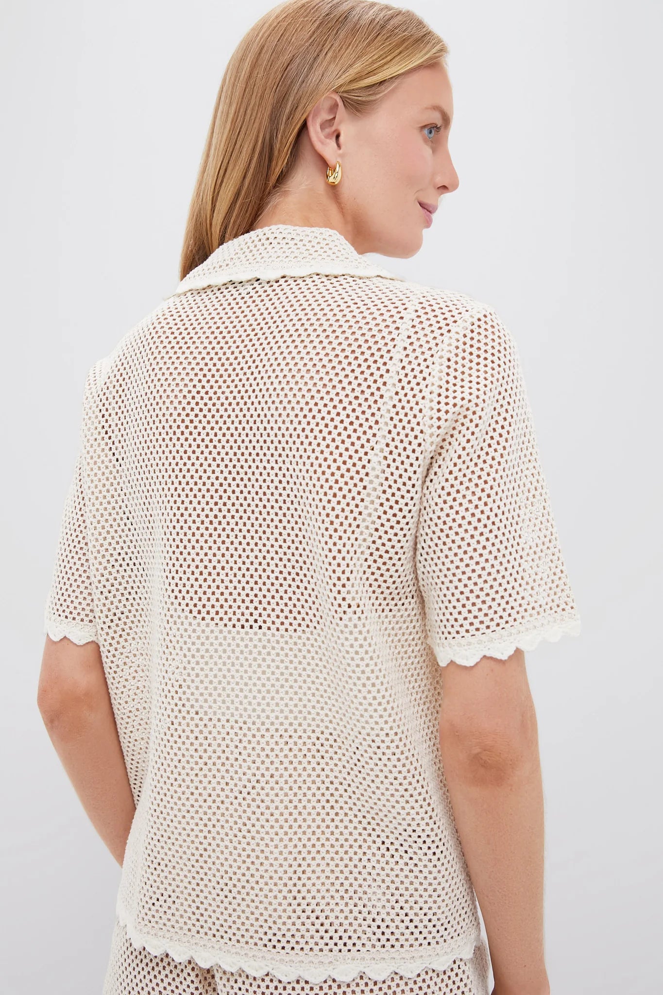 The Tan Sally Crochet Short Sleeve Shirt by SEA is expertly crafted with a crocheted design, delicate bird motifs, and scalloped trim for a touch of sophistication. Its versatile button-down silhouette allows for effortless style, perfect for any occasion - be it on the beach or off. Complete the look with the matching Tan Sally Crochet Shorts.