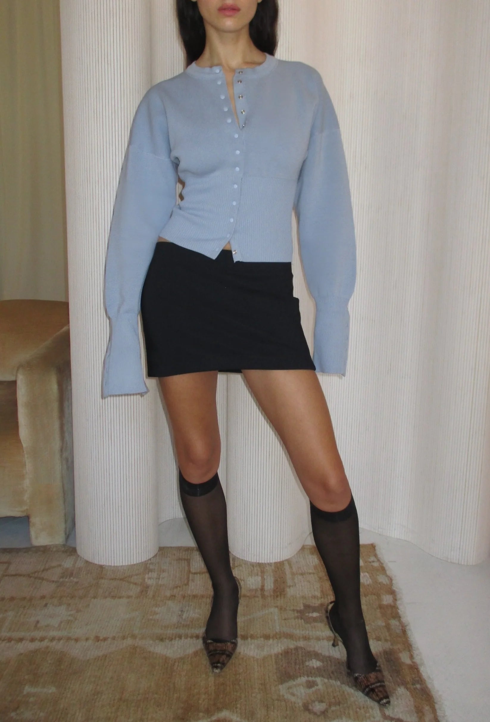 Elevate your style with The Weekend Knit Cardigan by Orseund Iris. Made from a luxurious blend of cotton and silk, this chunky Milano knit cardigan adds volume at the shoulders and cinches at the waist for a flattering silhouette. With its long and dramatic sleeves, it's the perfect addition to your wardrobe for a touch of sophisticated elegance.