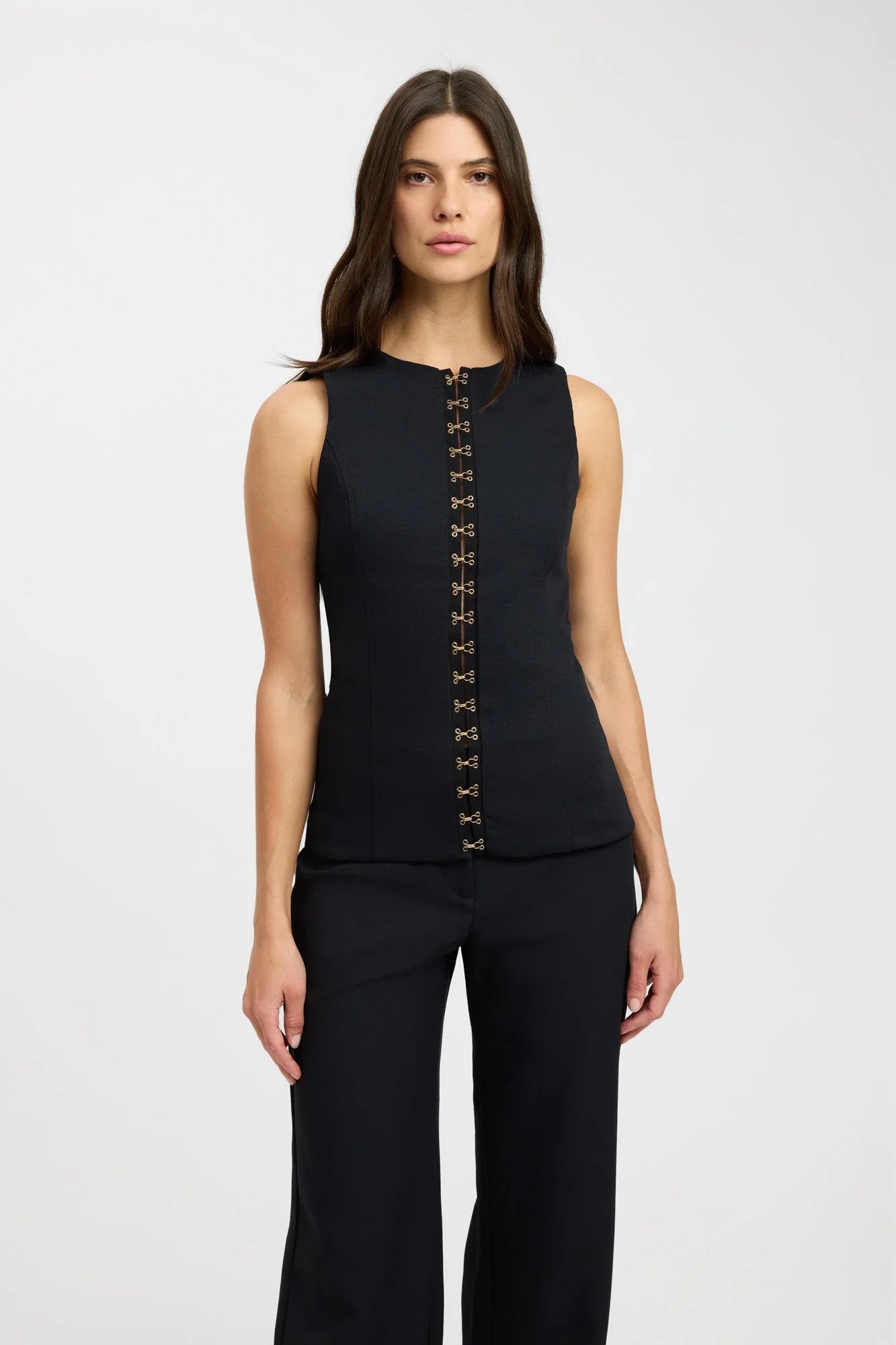 Elevate your fashion game with the luxurious Oyster Hook Crew Top. Made from suiting fabric, this top boasts a sophisticated high neckline and flattering flared hemline. The adjustable gold hook and eye details add elegance and customizable styling options. Make a statement with this must-have piece.