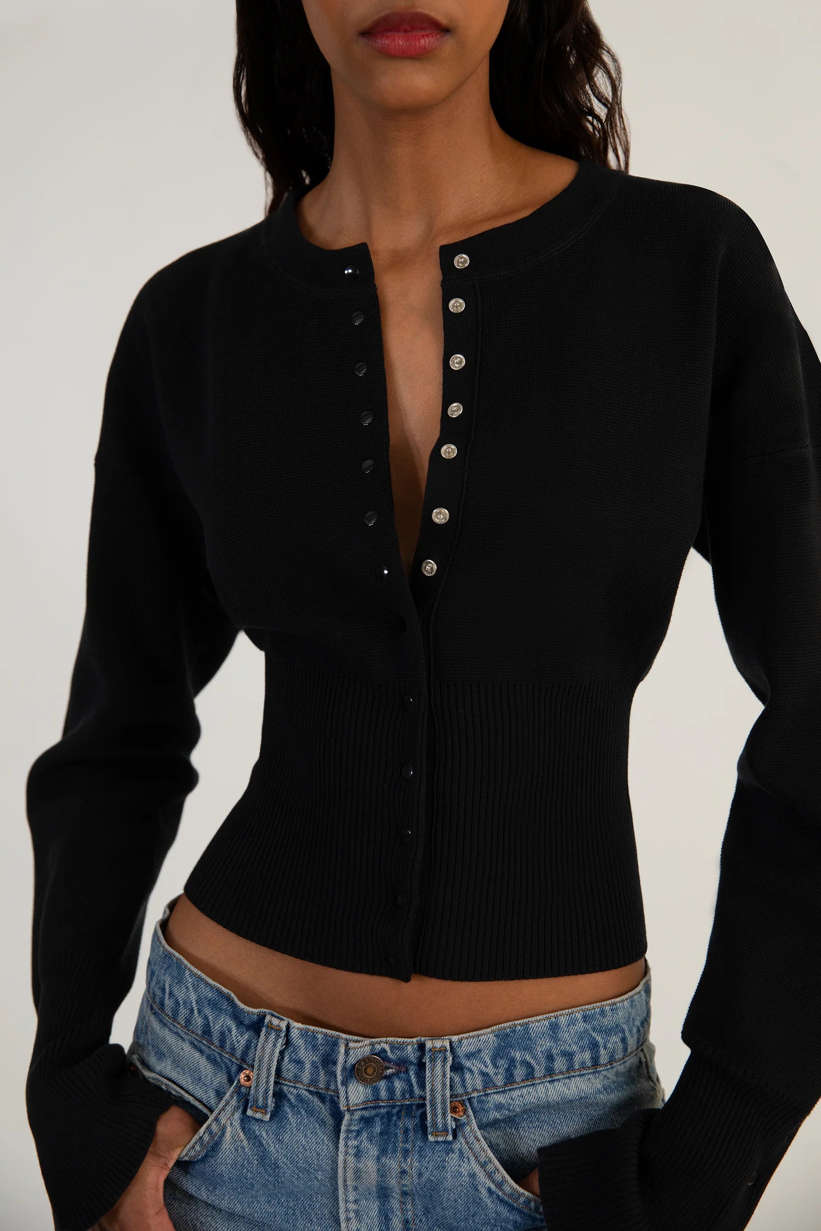 Elevate your style with The Weekend Knit Cardigan by Orseund Iris. Made from a luxurious blend of cotton and silk, this chunky Milano knit cardigan adds volume at the shoulders and cinches at the waist for a flattering silhouette. With its long and dramatic sleeves, it's the perfect addition to your wardrobe for a touch of sophisticated elegance.