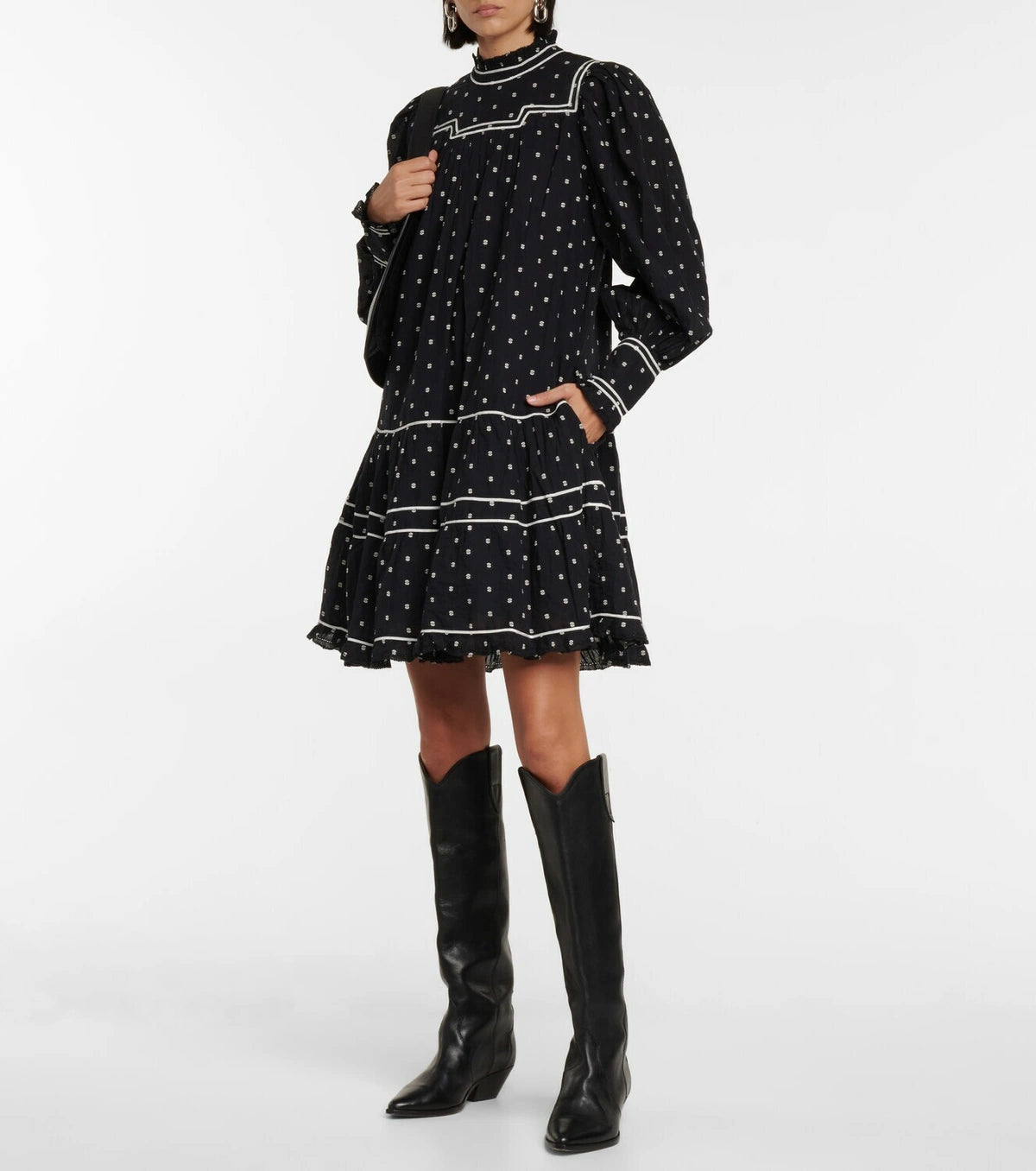 Feel flirty and feminine in the Blanche polka-dot cotton minidress by Ulla Johnson. The drop waist design and tiered skirt create a playful silhouette, while delicate lace trims and white piping add a charming touch. Made with black cotton poplin and embroidered polka-dots, this dress is both chic and whimsical.