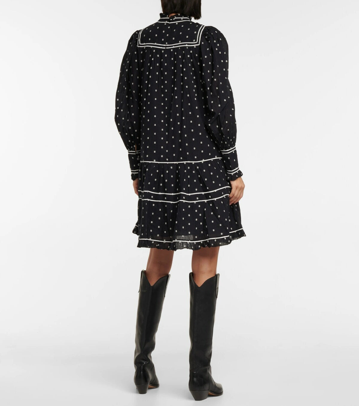 Feel flirty and feminine in the Blanche polka-dot cotton minidress by Ulla Johnson. The drop waist design and tiered skirt create a playful silhouette, while delicate lace trims and white piping add a charming touch. Made with black cotton poplin and embroidered polka-dots, this dress is both chic and whimsical.