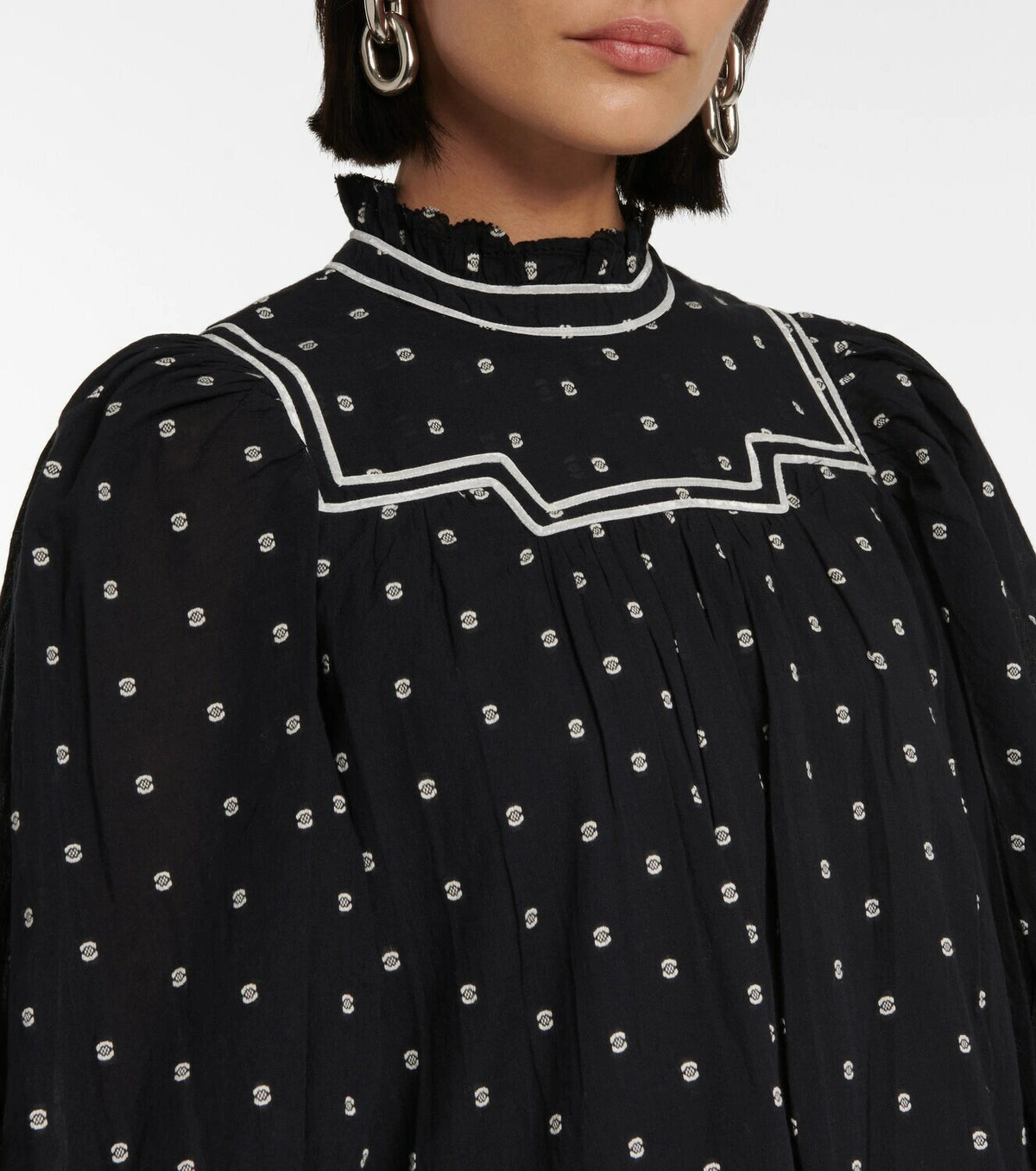 Feel flirty and feminine in the Blanche polka-dot cotton minidress by Ulla Johnson. The drop waist design and tiered skirt create a playful silhouette, while delicate lace trims and white piping add a charming touch. Made with black cotton poplin and embroidered polka-dots, this dress is both chic and whimsical.