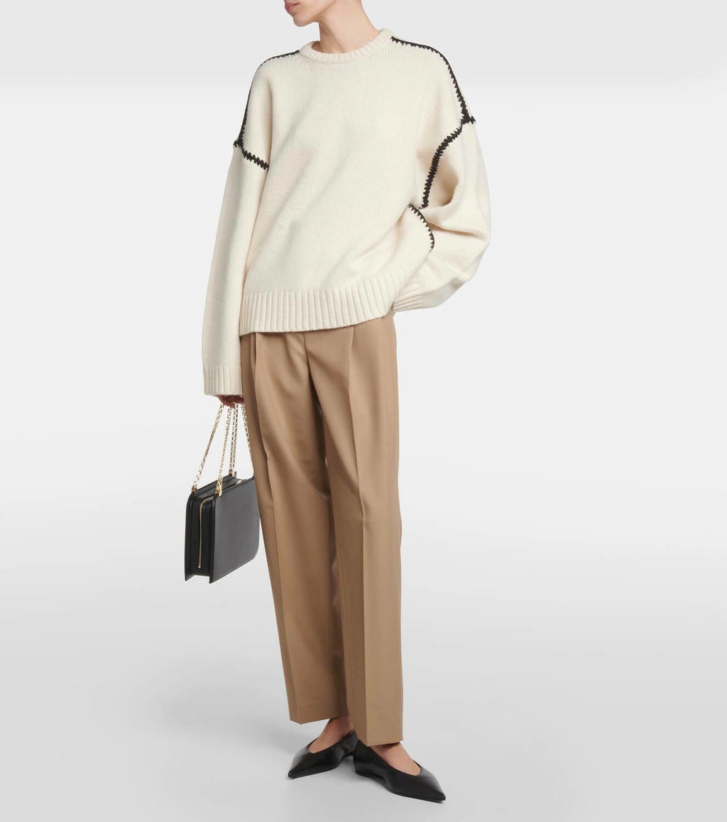 Discover understated elegance with this embroidered wool and cashmere sweater by Totême. Crafted in a wide silhouette from mid-weight wool blended with cashmere, it provides exceptional warmth and softness. The contrasting embroidery along the shoulders and armholes adds a refined artisanal touch, elevating your everyday knitwear with a distinctive, modern flair. Perfectly embodying Scandinavian minimalism, this sweater offers both comfort and style for a timeless, versatile wardrobe staple.
