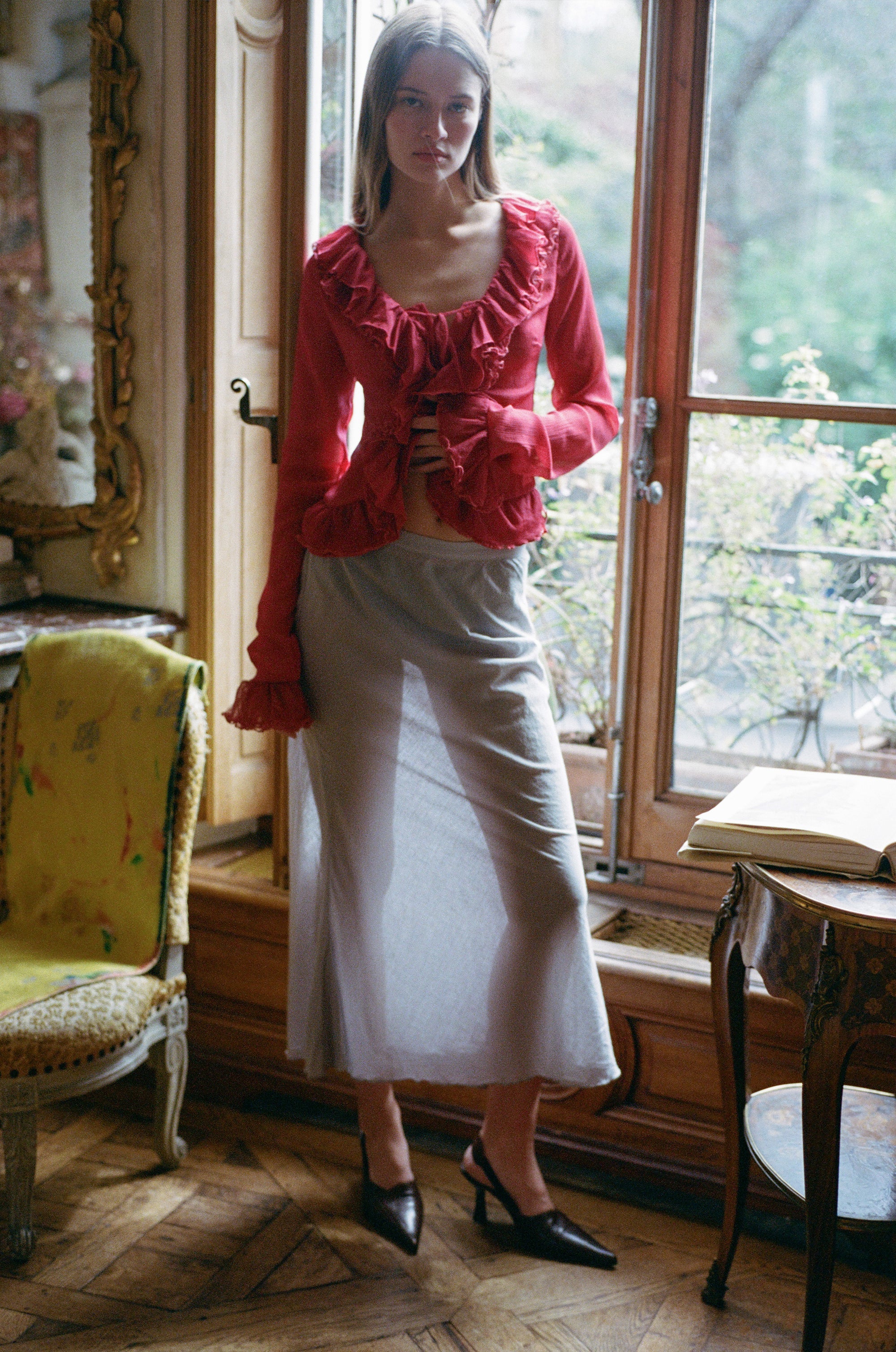 Indulge in the luxuriously elegant Maia Blouse by With Jean. With long sleeves, delicate ruffle detailing, and a semi-sheer design, this blouse exudes sophistication and charm. The button front closure adds a touch of understated class, making it the perfect addition to any upscale wardrobe. Unleash your inner fashionista with this exclusive piece.