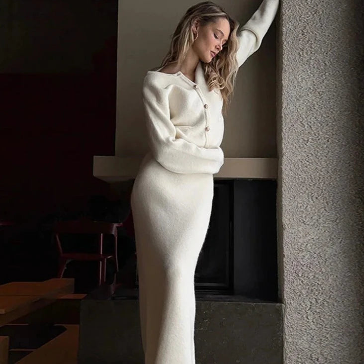 Upgrade your wardrobe with Ensemble Dora: an elegant and stylish 2 piece set featuring a Golden O-neck cardigan and white knit midi skirt. Perfect for any occasion, this single-breasted ensemble will add a touch of elegance to your outfit while keeping you cozy and comfortable.