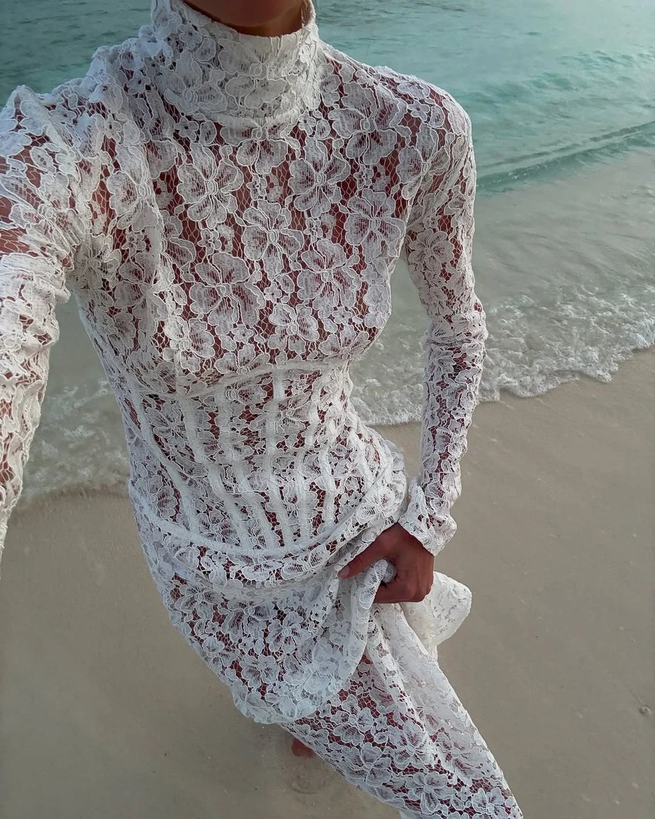 The Isadora gown by The New Arrivals Ilkyaz Ozel epitomizes refined elegance with its pristine white silhouette and architectural design. Featuring a structured boned bodice that sculpts the figure with precision, this statement piece showcases a sophisticated mock neck and innovative cuff zips for versatile styling. The concealed rear zip fastening ensures a seamless, polished finish. Perfect for those who appreciate couture-inspired details and timeless sophistication.