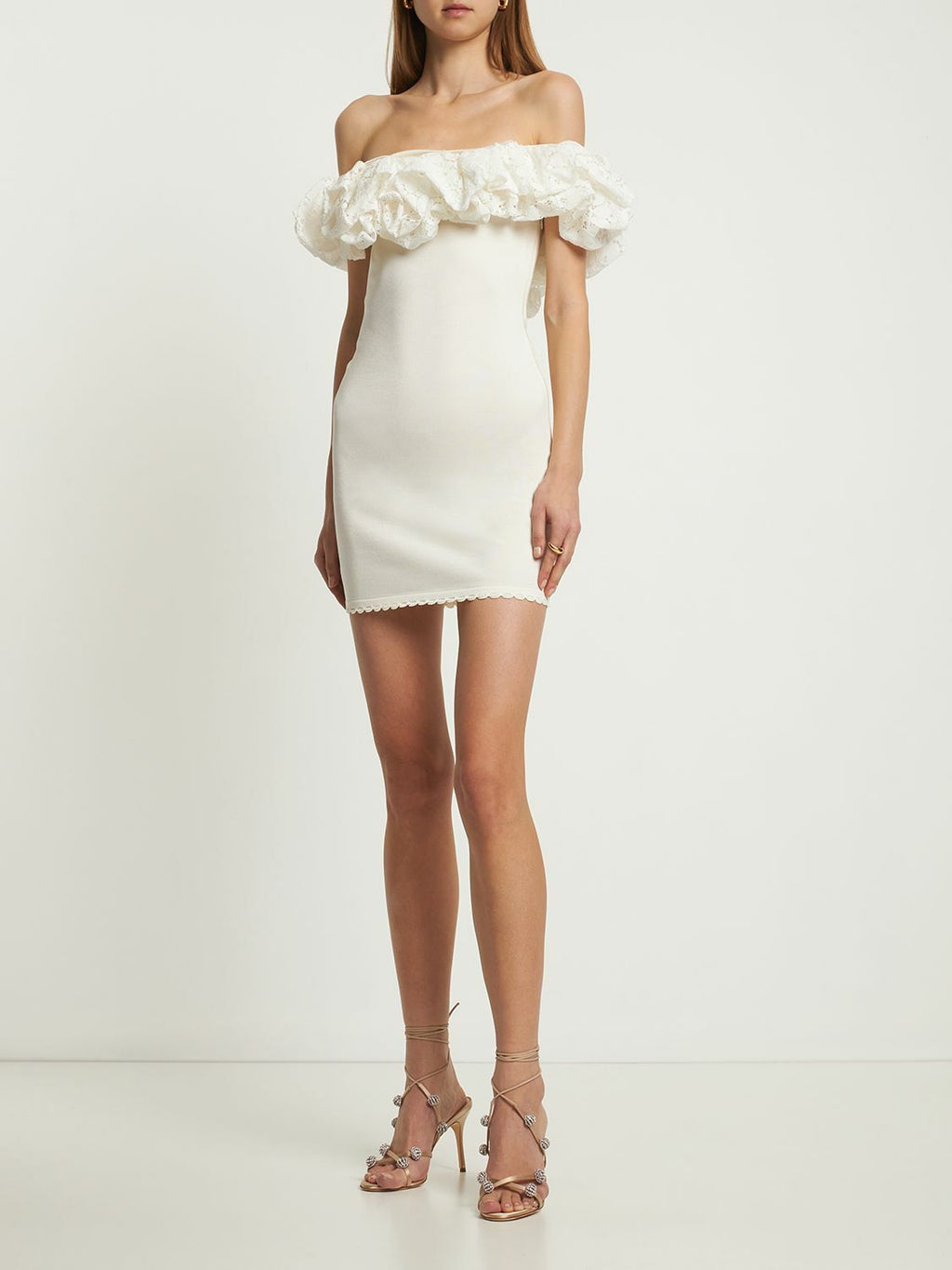 Embrace effortless charm with the Sangallo Knit Ruffle Mini Dress by Alexandre Vauthier. Featuring a playful off-the-shoulder ruffled lace neckline, this dress adds a flirty touch to your look. Simply pull it on and enjoy its comfortable fit, while the unique lace pattern ensures every dress has its own special flair. Perfect for twirling into any sunny day or festive night out!