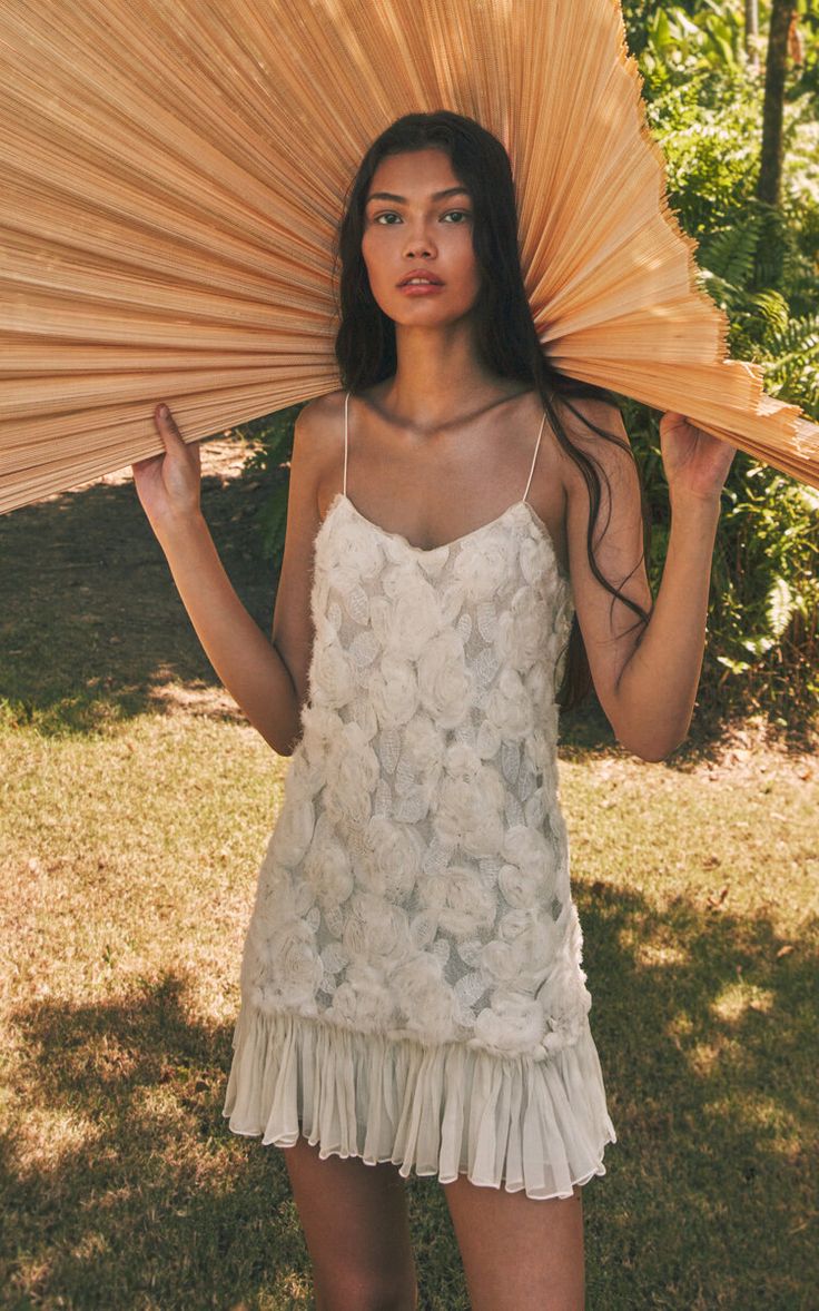 Fall in love with the Blanc mini dress by Alexis! This romantic design features intricate rosette details, made from lightweight georgette material. The flirty frilled hem adds a touch of playfulness. Perfect for any occasion with its concealed zip fastening. Get yours now!