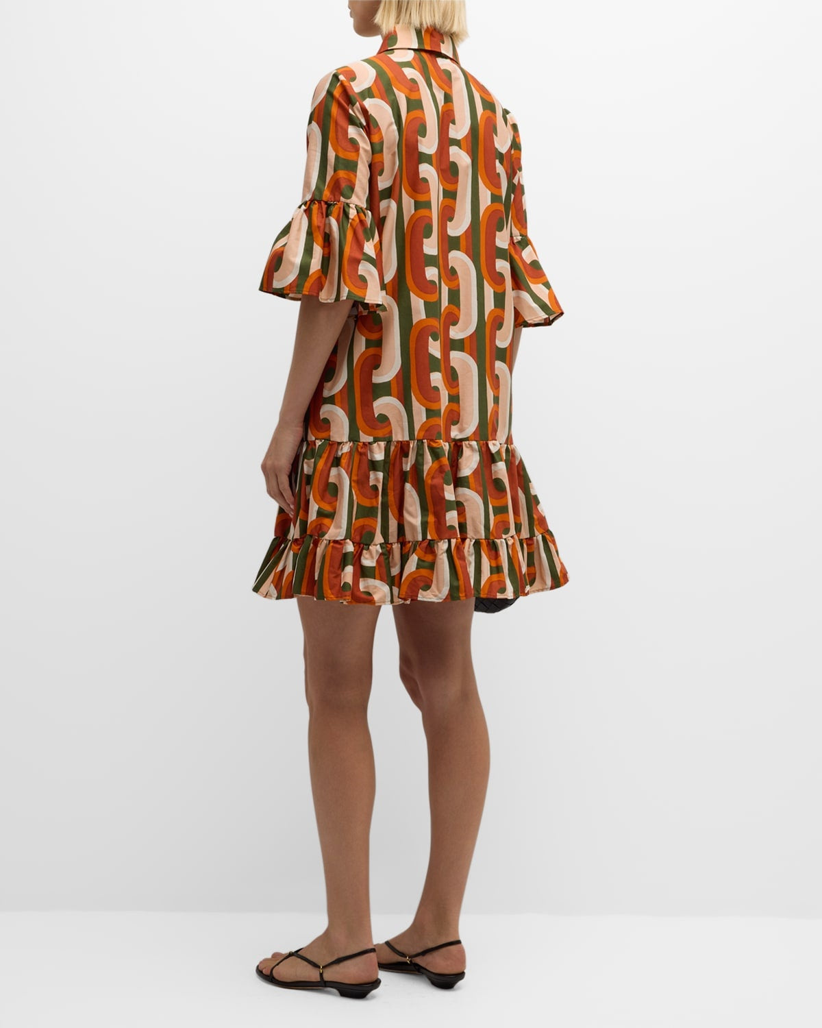 Elevate your everyday wardrobe with the DoubleJ Choux shirtdress, a sophisticated Italian-crafted piece that effortlessly transitions from day to night. This cotton mini dress features an eye-catching chain-link print and charming tiered ruffle hem that adds movement and dimension. The classic point collar and button-front design offer timeless appeal, while practical side split pockets keep essentials within reach. 