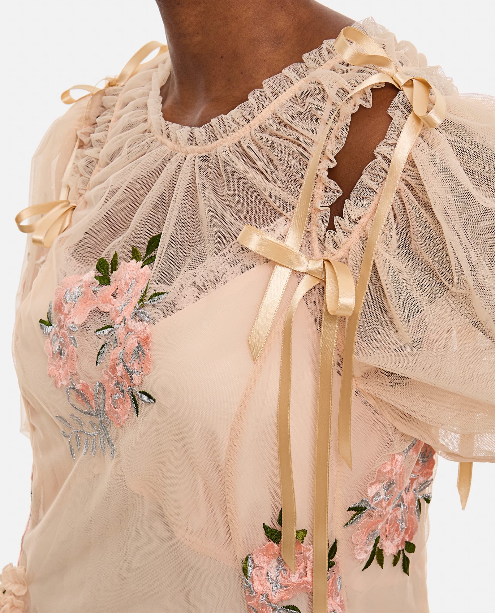 This midi-length dress by Simone Rocha features elegant draped detailing at the waist that flatters your silhouette. Short puff sleeves add a touch of romantic charm, enhanced by delicate applied bows on the shoulders. Embroidered flower accents provide subtle texture and femininity. Designed without a petticoat, the nude-colored fabric offers a smooth, graceful flow perfect for any occasion that demands effortless sophistication.