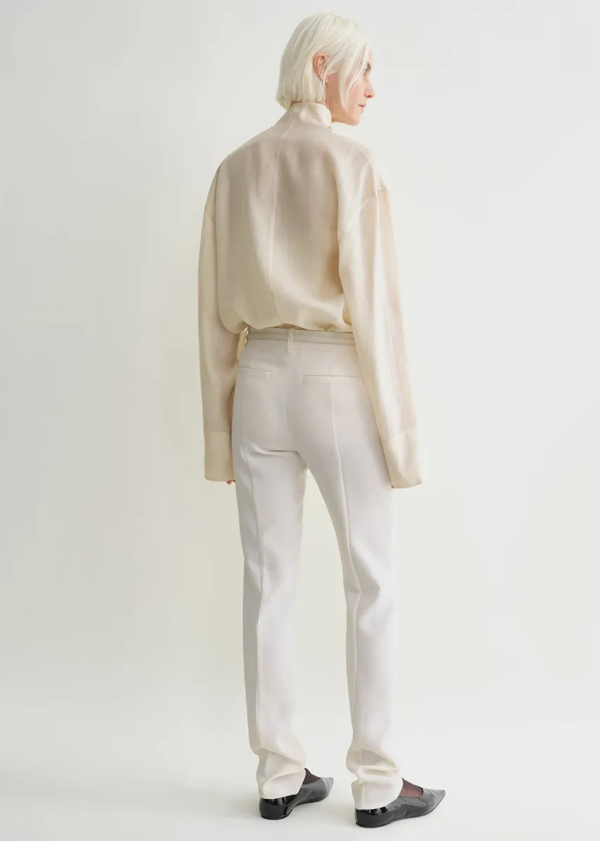 Elevate your wardrobe with this oversized funnel-neck organza blouse by Toteme, designed for effortless sophistication. The lightweight, semi-sheer fabric creates a delicate layering effect when paired with the included cami top. Its roomy fit and elegant neckline bring both comfort and style, making it ideal for pairing with tailored trousers for a polished daytime look. Perfect for those seeking a chic, versatile piece that enhances any outfit with a graceful touch.