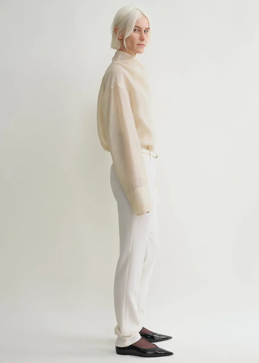 Elevate your wardrobe with this oversized funnel-neck organza blouse by Toteme, designed for effortless sophistication. The lightweight, semi-sheer fabric creates a delicate layering effect when paired with the included cami top. Its roomy fit and elegant neckline bring both comfort and style, making it ideal for pairing with tailored trousers for a polished daytime look. Perfect for those seeking a chic, versatile piece that enhances any outfit with a graceful touch.