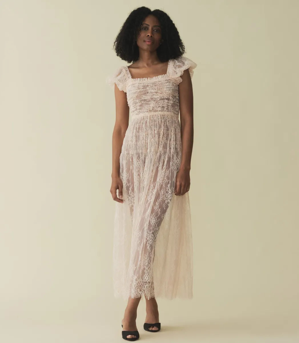 Embody elegance and grace in the Pamelina Dress in Petunia by Doen. With its delicate lace fabric, charming details like puffed sleeves and a square neckline with ruffles, and an ethereal tulle-lined skirt, this dress is perfect for any special occasion. Embrace timeless beauty and sophistication in this captivating dress.