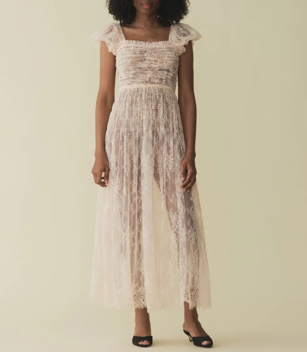 Embody elegance and grace in the Pamelina Dress in Petunia by Doen. With its delicate lace fabric, charming details like puffed sleeves and a square neckline with ruffles, and an ethereal tulle-lined skirt, this dress is perfect for any special occasion. Embrace timeless beauty and sophistication in this captivating dress.
