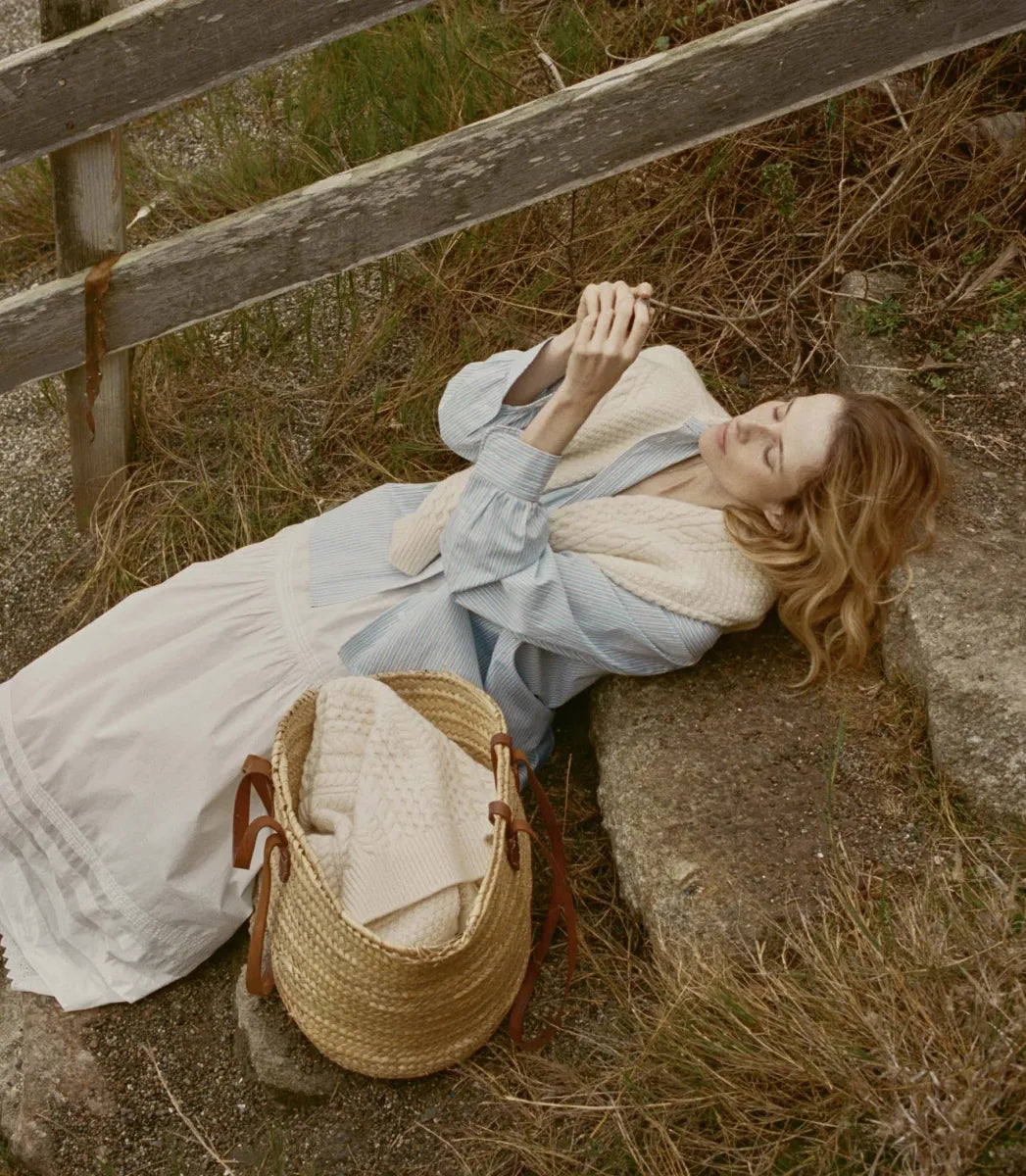 Elevate your wardrobe with the Hava Top in Santorini Stripe by Doen. Made from luxurious Italian cotton, this button-down features a sophisticated Santorini Stripe pattern and mother-of-pearl buttons. The embroidered and shirring details add unique flair to its tailored silhouette, perfect for both casual and polished looks. Versatile and elegant, it's a must-have for any fashion-forward individual.