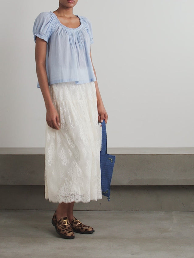 Elevate your wardrobe with the Sebastiane tiered lace midi skirt by Doen—a sophisticated piece that effortlessly transitions from day to evening. Crafted with delicate layered lace, this midi skirt offers romantic elegance with a modern silhouette that flatters every figure. The tiered design creates beautiful movement and dimension, while the midi length provides versatile styling options for any occasion. 