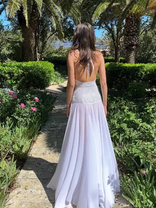 Get ready to turn heads in the Rosalia Maxi Dress. The halterneck tie top and double layered chiffon dress create a flirty and feminine silhouette, while the tailored fit accentuates your waistline. Perfect for weddings, bachelorettes, birthdays, and any special occasion. Comes with a concealed side zip for a seamless look.