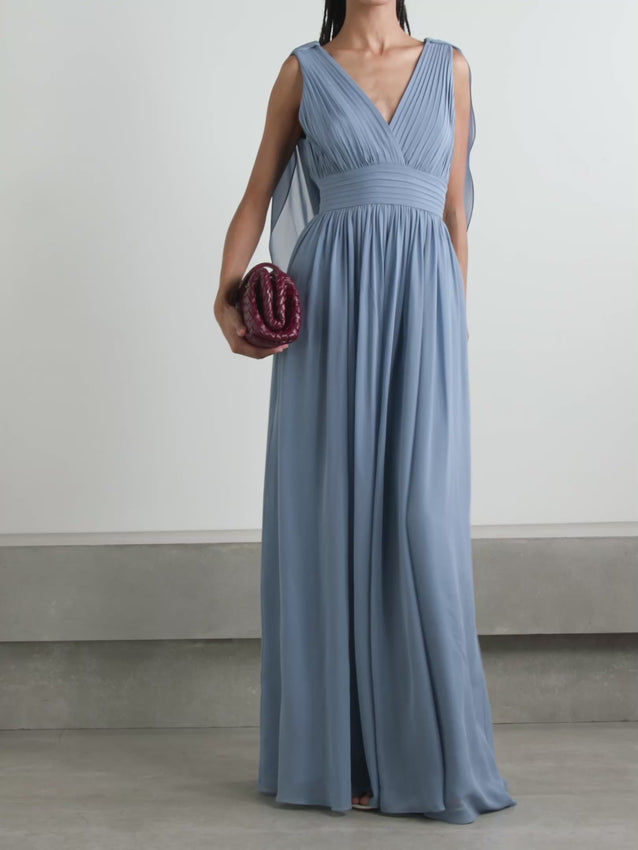 Elevate your evening with this exquisite cape-effect gown by Elie Saab, crafted from luxurious silk-georgette that drapes with effortless elegance. The meticulously pleated silhouette creates dynamic movement and dimension, while the dramatic cape detail adds a touch of haute couture sophistication. Perfect for formal occasions, galas, and red-carpet moments, this timeless piece combines architectural design with refined femininity. 