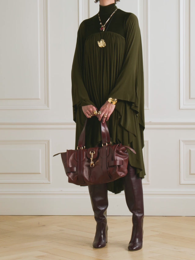 Inspired by Zimmermann's Fall '25 runway aesthetic, this gathered jersey dress captures the essence of fluid elegance. The luxurious fabric drapes beautifully with every movement, while strategic gathering at the velvet-trimmed yoke creates refined dimension. A sophisticated mock neckline completes the look, offering a modern silhouette that transitions effortlessly from day to evening. Perfect for those who appreciate understated luxury and graceful design.